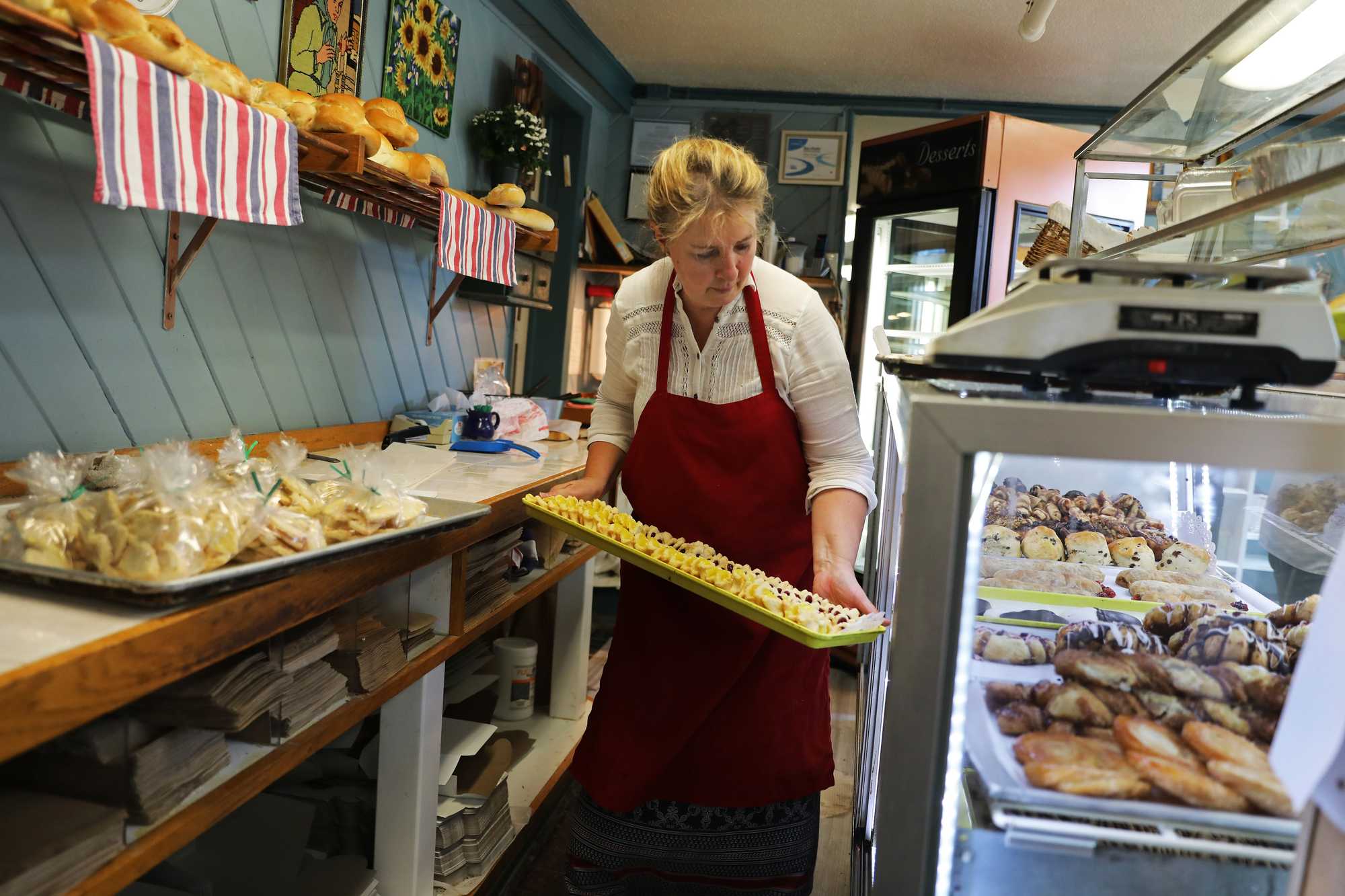 Delmalyn Vaughn put a tray of lemon and raspberry pinch cookies into the case.