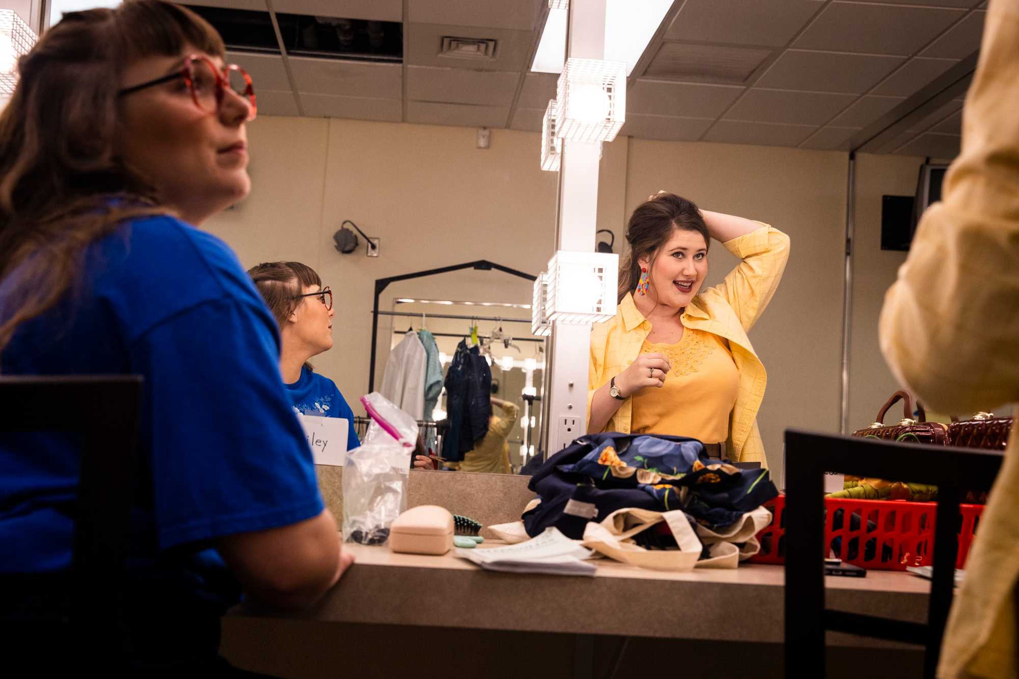 Hailey Cuellar (left) watched as Rebecca Grizzell put the finishing touches on her hair.