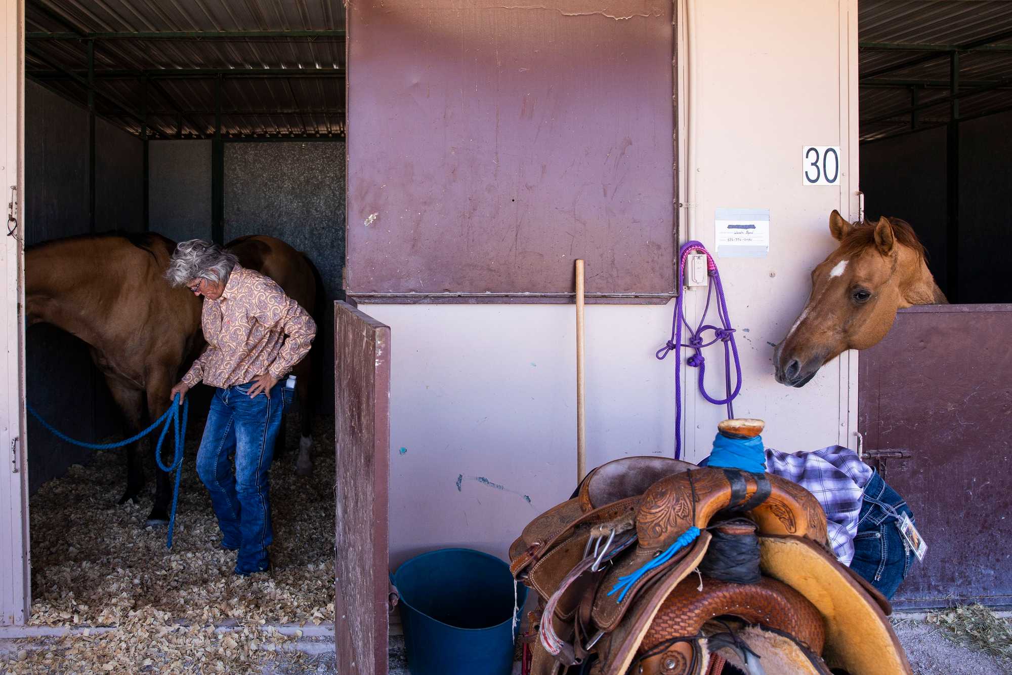Cindy Cowan walked her 22-year-old horse, Superman, into his stall after competing at the rodeo.