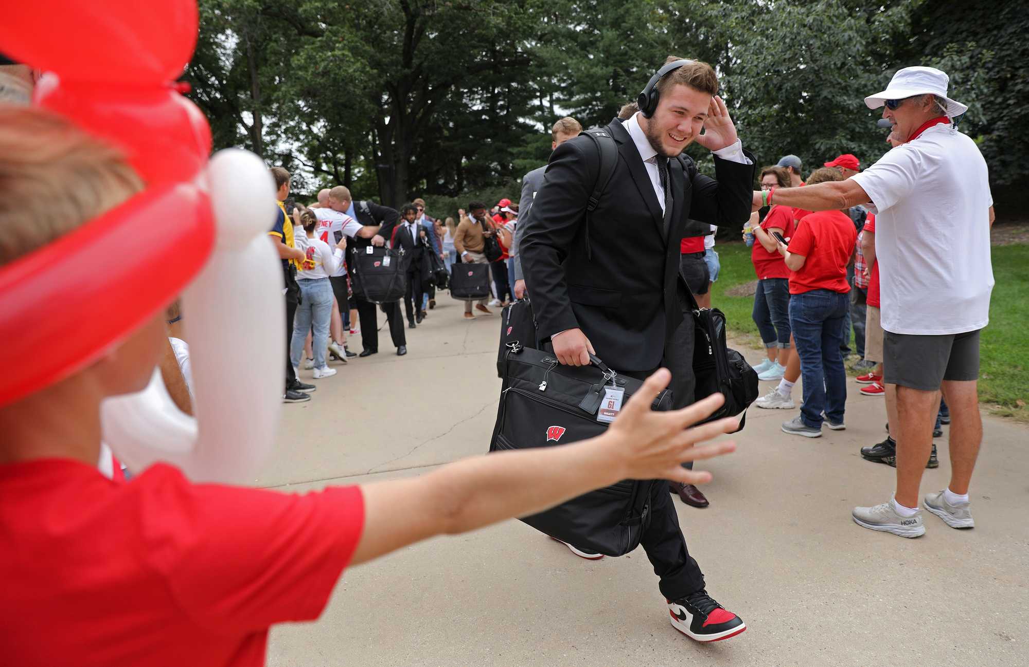 Wisconsin players and coaches walked through a welcoming reception line onto campus before the game.