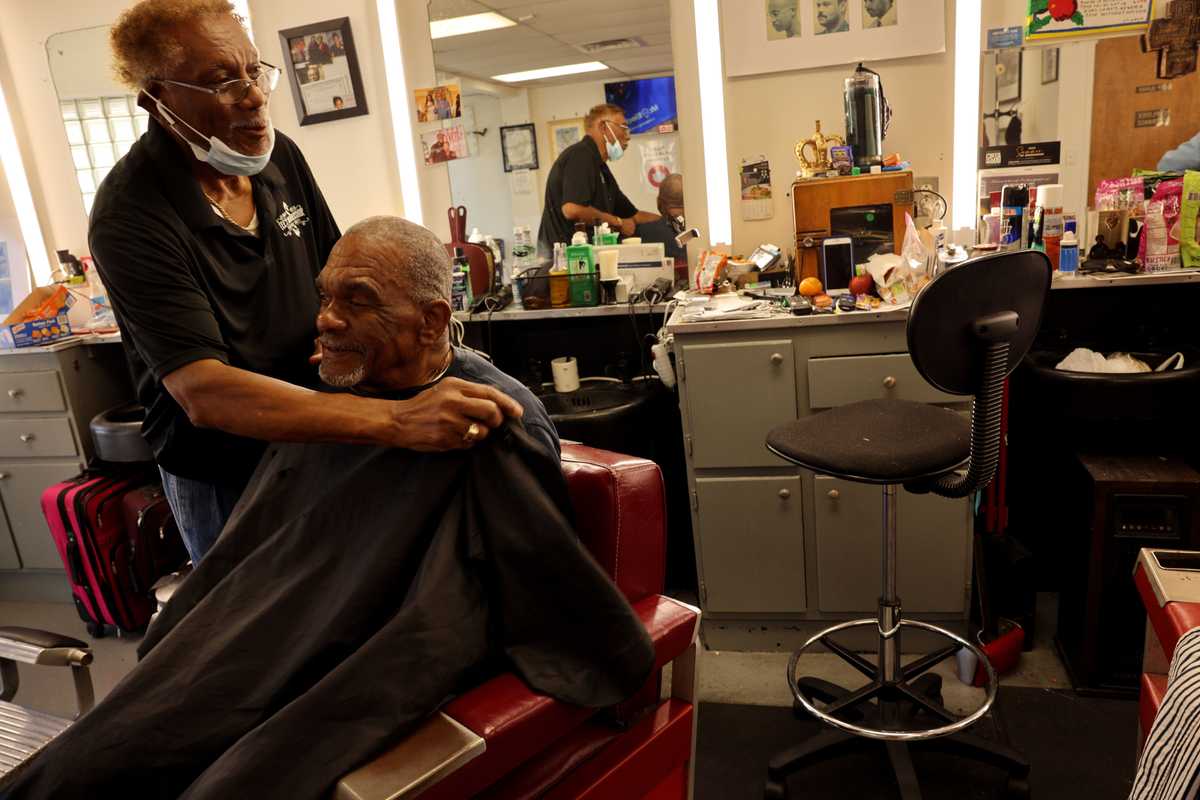 Owner-operator Willie Sells worked on customer Rudy Wilson at Tee’s Barbershop at Black Wall Street Corridor in the Greenwood District of Tulsa, Okla., on Sept. 9.