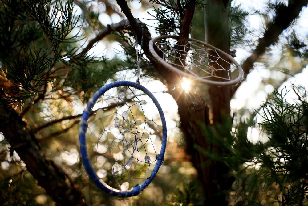 Dreamcatchers are tied to a tree branch behind the grave of White Buffalo Girl, a toddler who died on the Trail of Tears in 1877. Locals still honor her father's request to tend her grave.