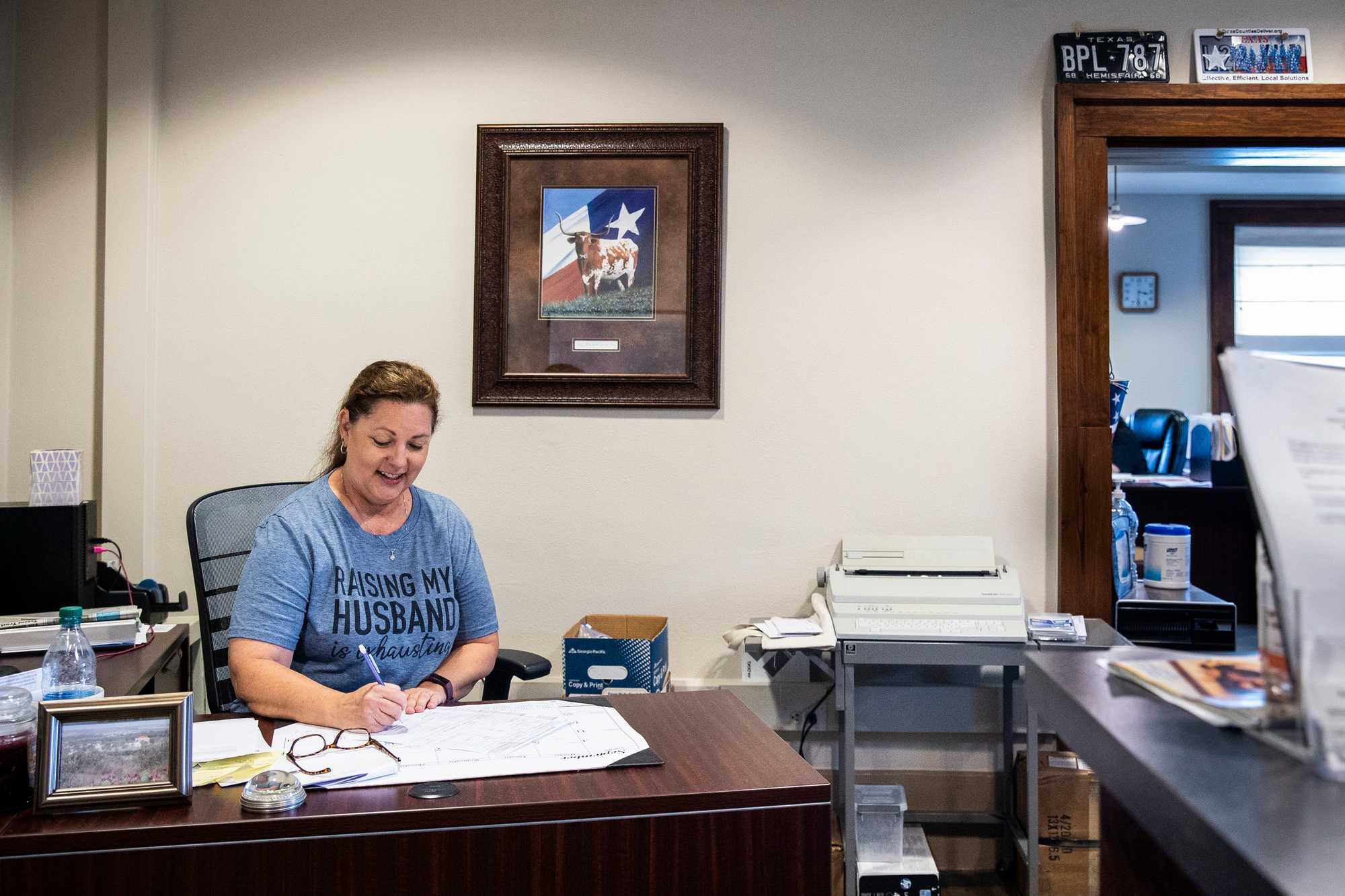 Holly Jackson, who is married to William, at work in the courthouse in Miami, Texas. Her shirt said, "Raising my husband is exhausting." 