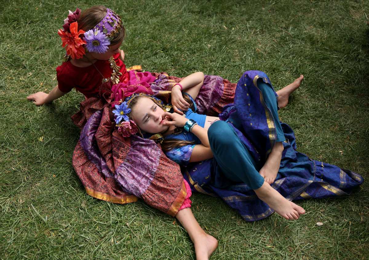 Lyra Hungerford (right), 7, rested with her sister, Aria, 9 before they performed with Akashic Moves Belly Dance at the Hyde Park Street Fair in Boise, Idaho. 
