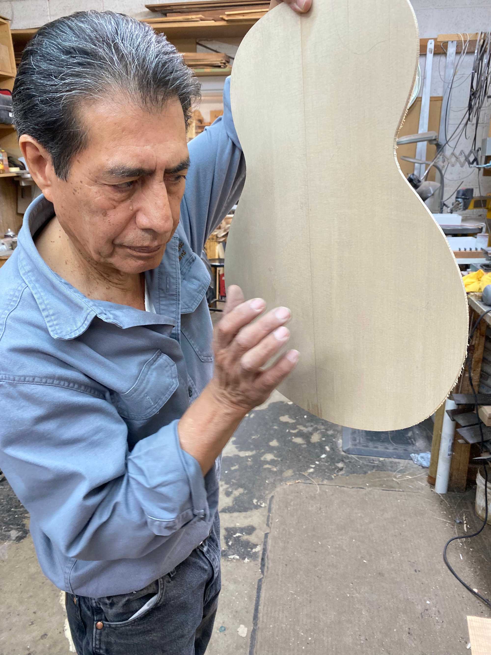  Rick Pimentel, president of Pimentel & Sons Guitarmakers, can tell how good a guitar will sound when it's completed by tapping on the wood throughout the process of making it. 