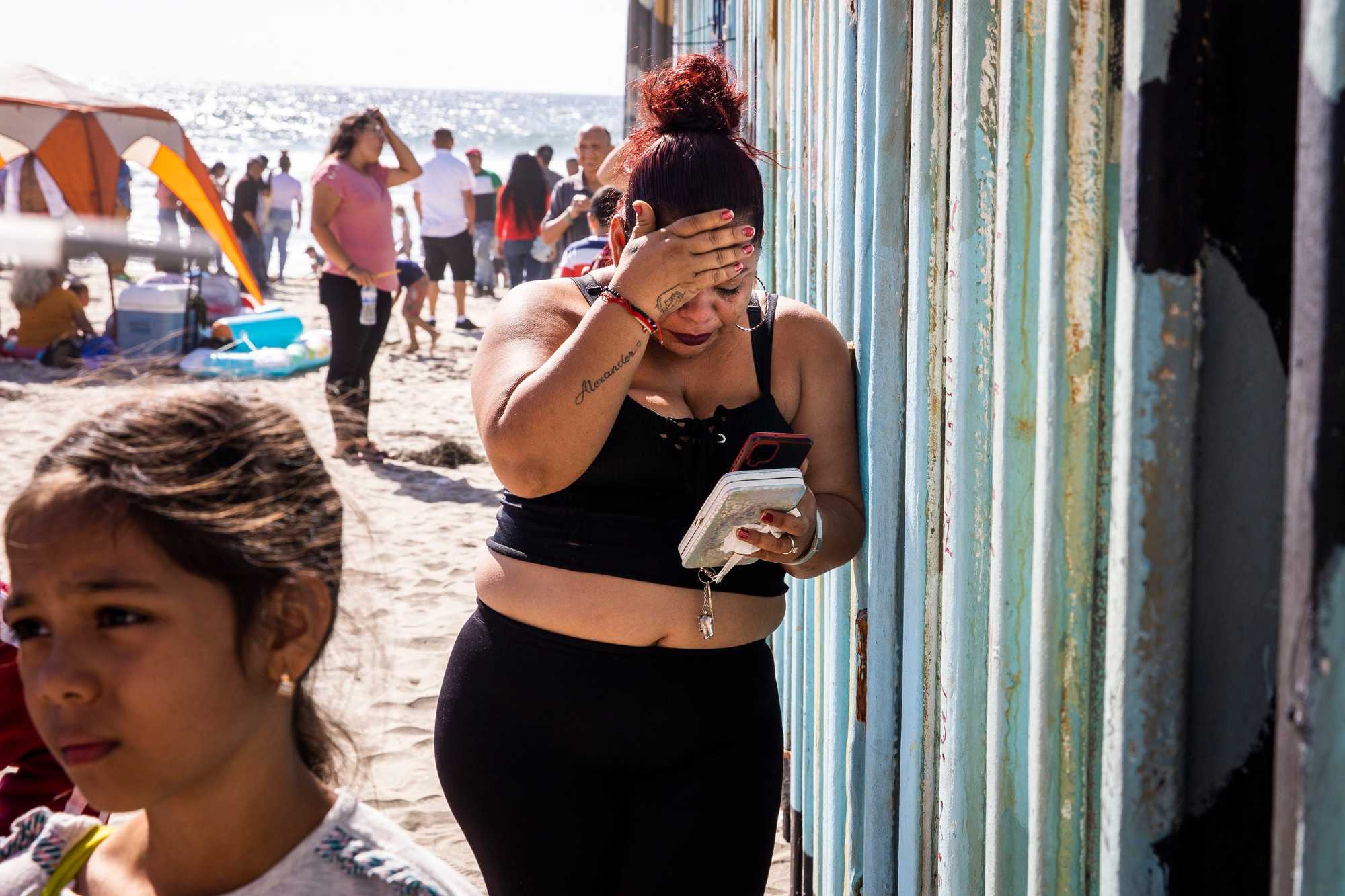 A woman cried while FaceTiming her family on the other side of the border wall. She was not aware that she would no longer be able to touch her family at the wall that separates Tijuana from San Diego. 
