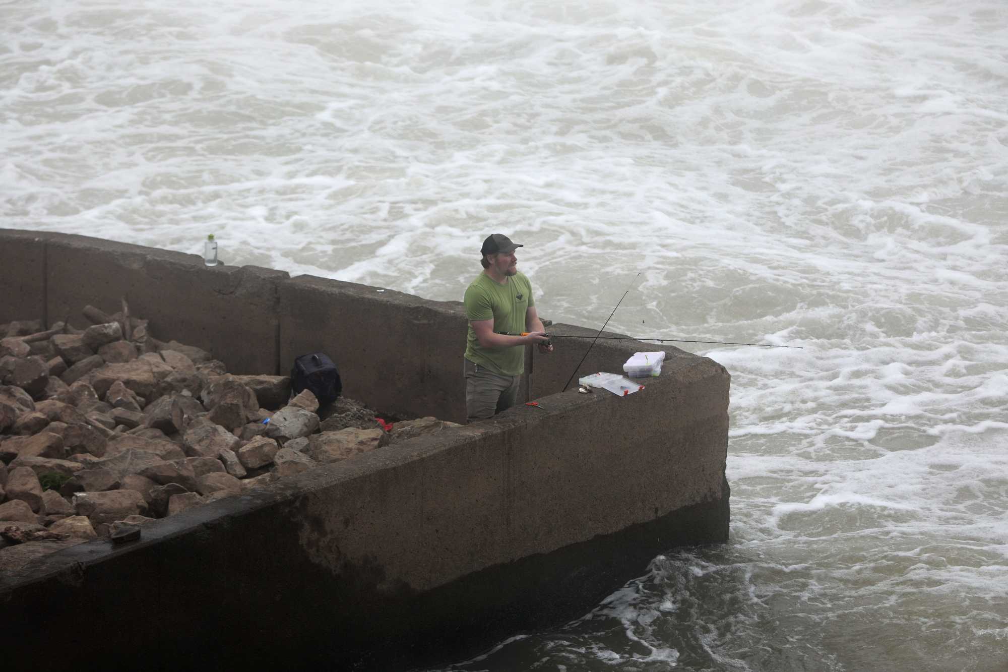 Ricky Jackson fished on the Ohio River, at the Robert C. Byrd Locks and Dam in Gallipolis, Ohio. The swift current is caused by the opening of rollers on the dam to allow more water to flow downstream.