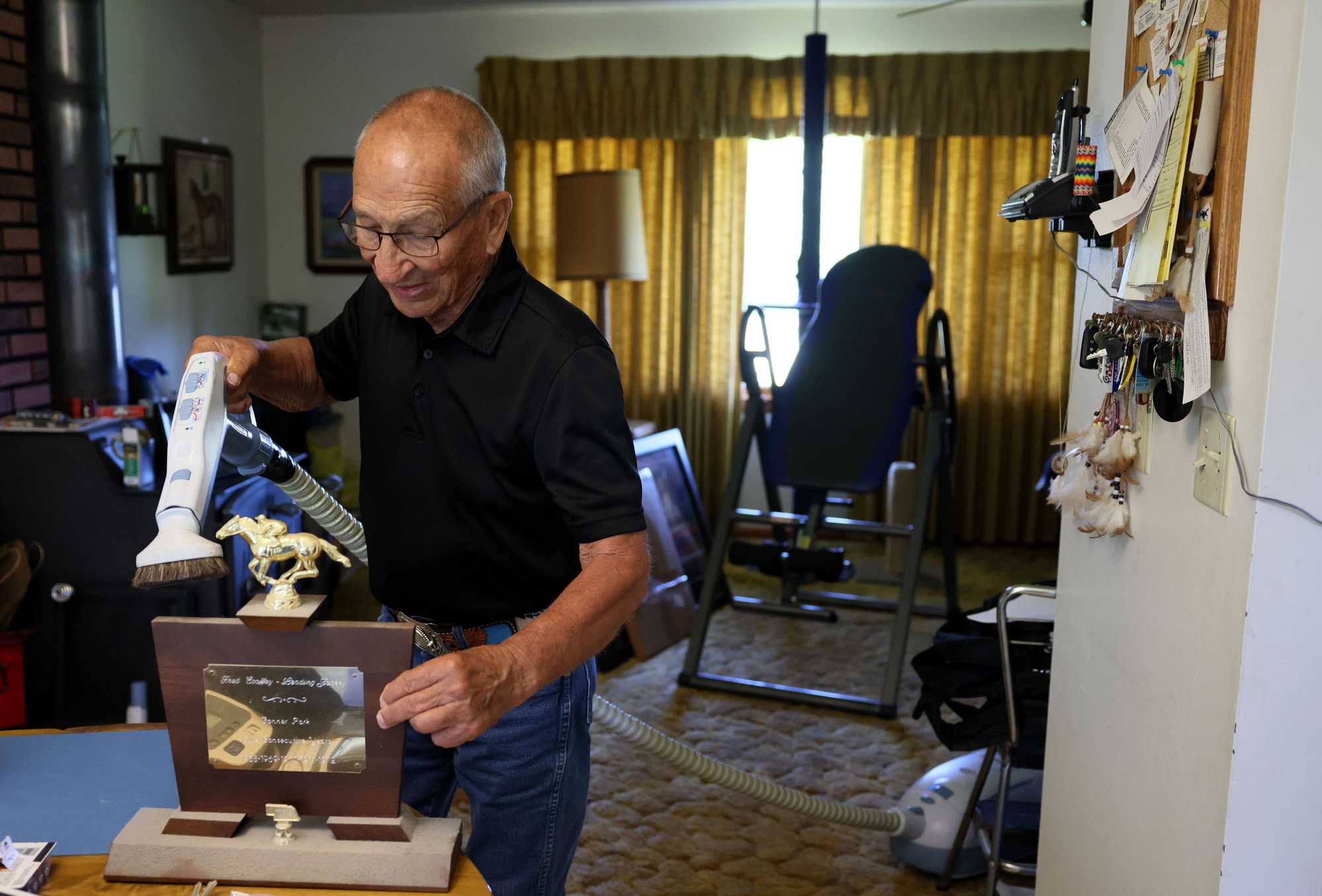 Ecoffey vacuumed dust from some trophies from his storied racing career.