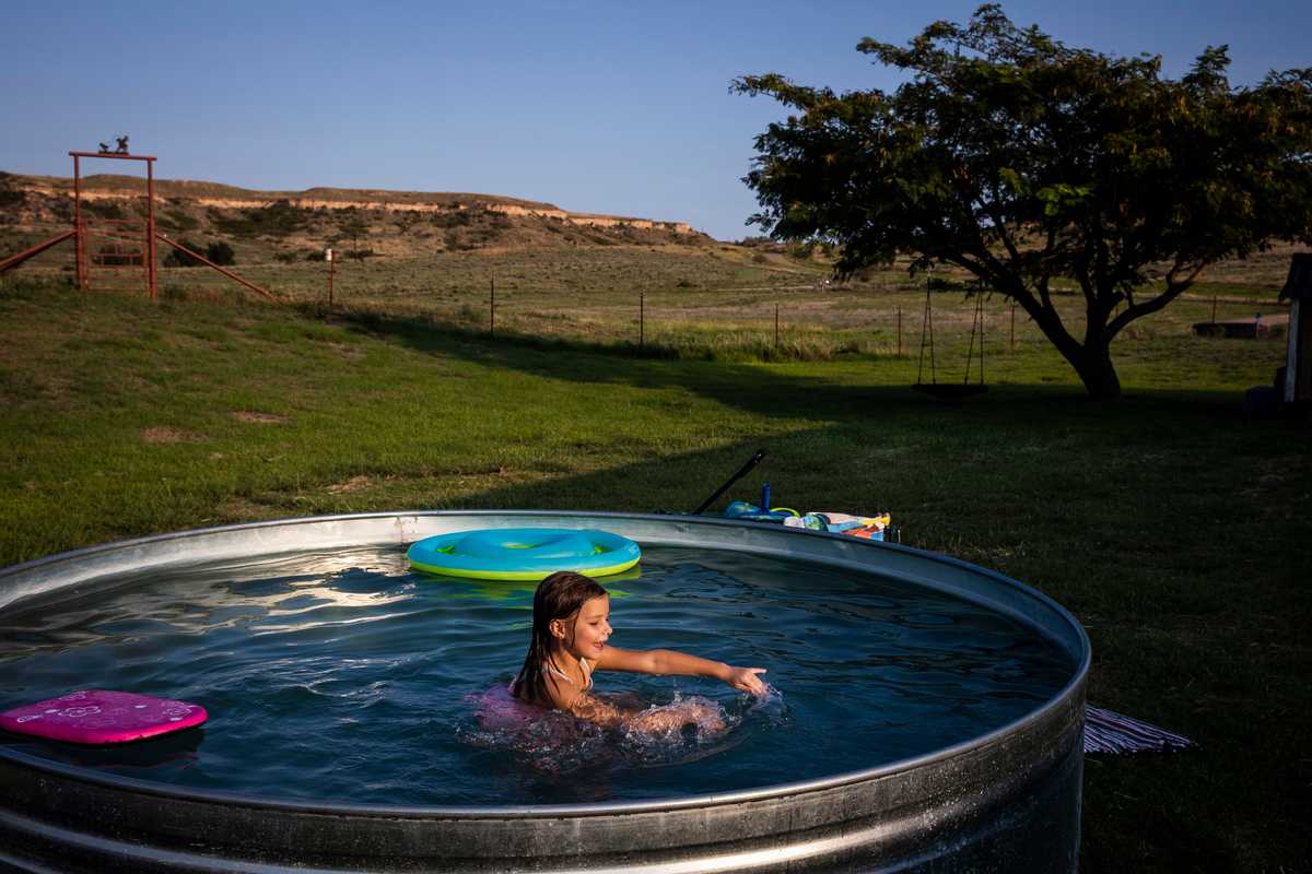 Sloane Booze, 6, swam in a stock tank pool at her grandparent’s ranch in Miami, Texas. 