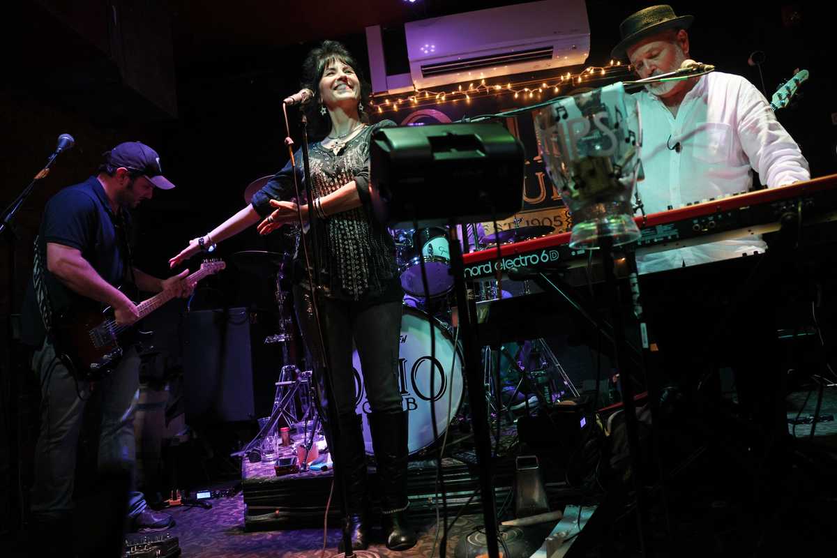 Dona Pettey, owner of The Ohio Club and lead singer of The Ohio Club Players, encouraged the crowd after Steve Malec's guitar solo. 