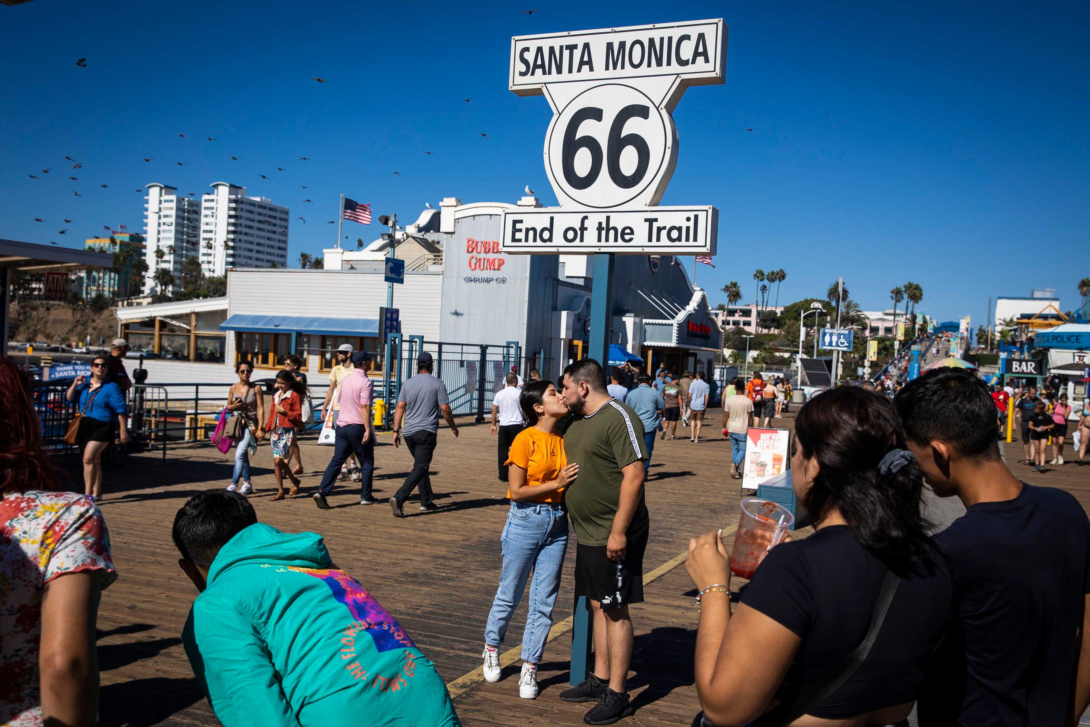 Tourists had their picture taken with the Route 66 sign, marking the end of the trail on the Santa Monica Pier in California.