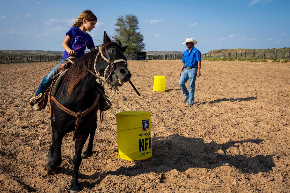 Sloane Booze, 6, practiced riding around barrels with the help of her father, Jake, while on her grandparent’s ranch in Miami, Texas. 