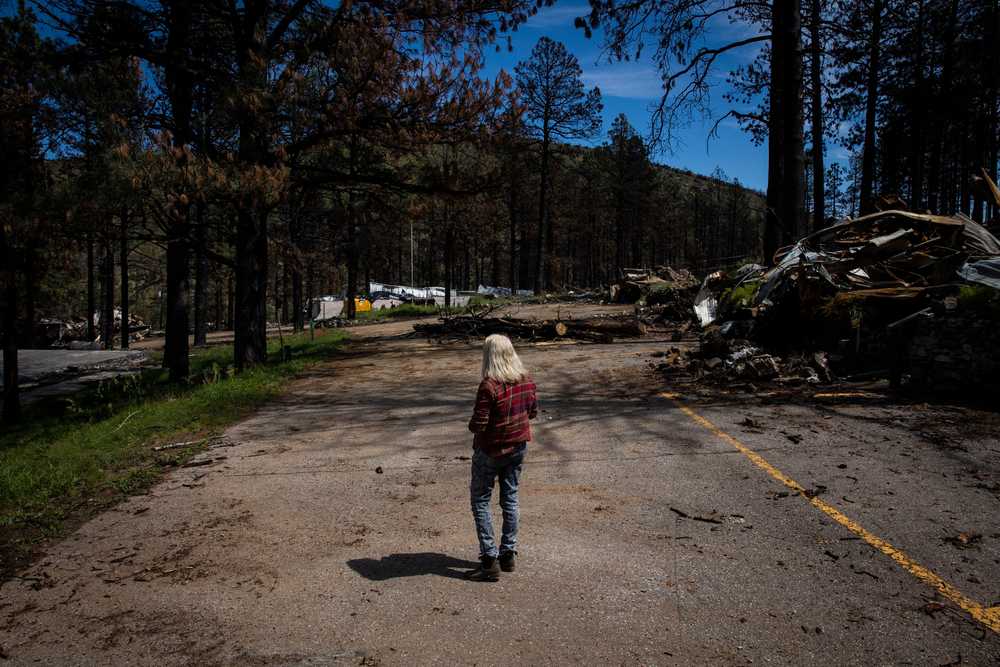 Cyn Palmer looked out across the wreckage of the Pendaries Village & Golf Resort, where she sometimes worked near her home in New Mexico. Palmer's home was damaged in an April wildfire.