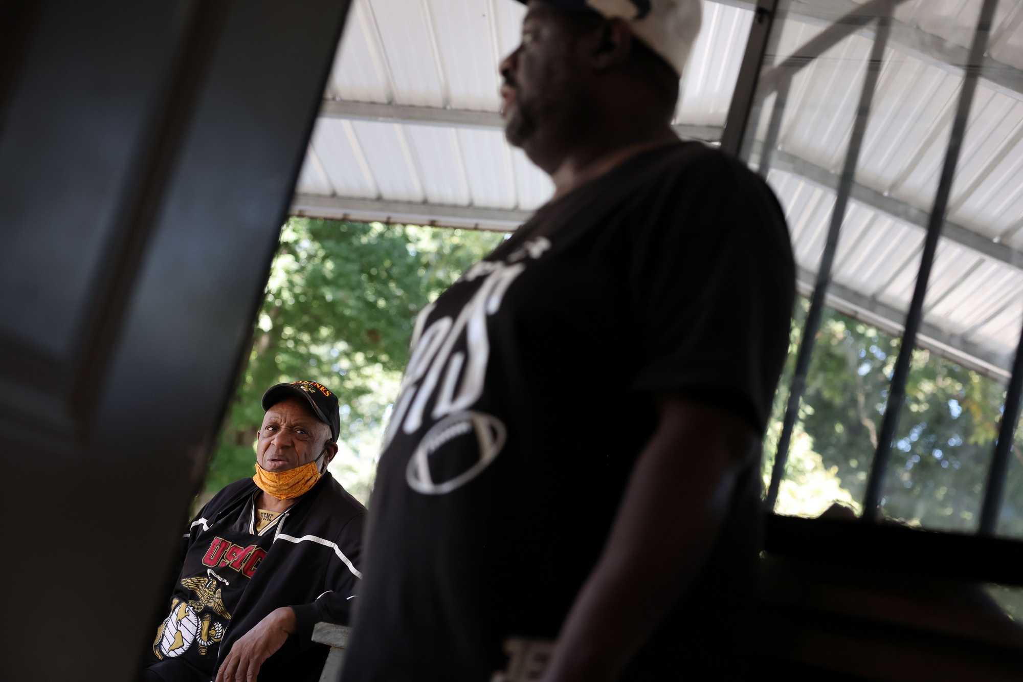 James H. Jones Jr. (right) talked with his cousin Irish Williams during a visit to Jones' Bar-B-Q.