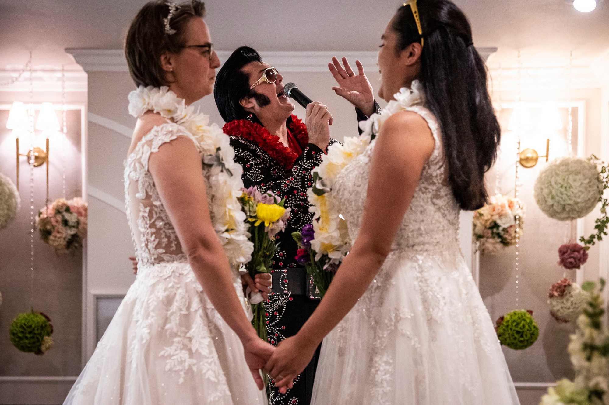 Brendan Paul, an Elvis impersonator at the Graceland Wedding Chapel in Las Vegas, sang for newlyweds Sarah and Stephanie Logia.  