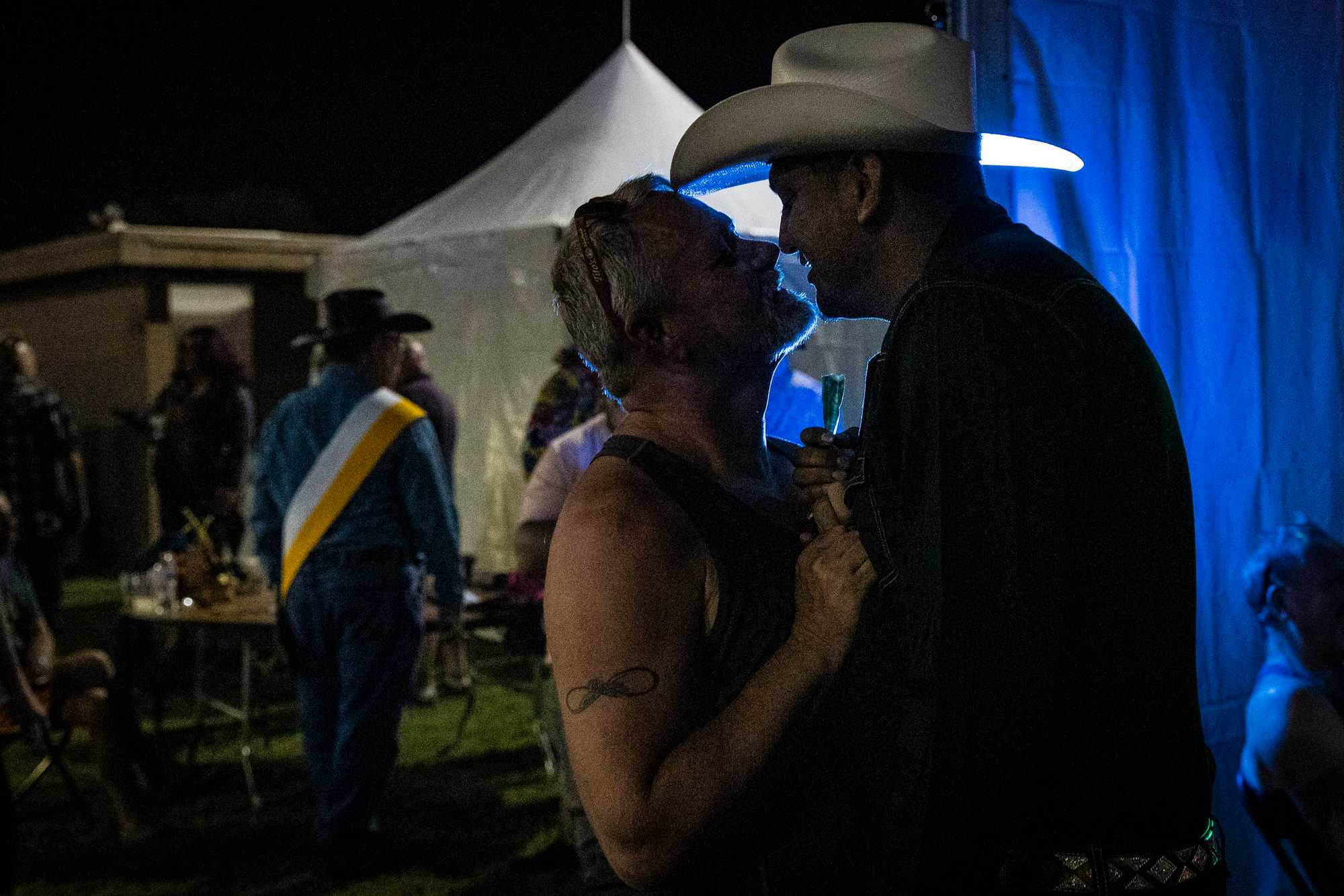 Jamie Walker (left) gave a dollar to Danny Love while Love performed at the BigHorn Rodeo in September.