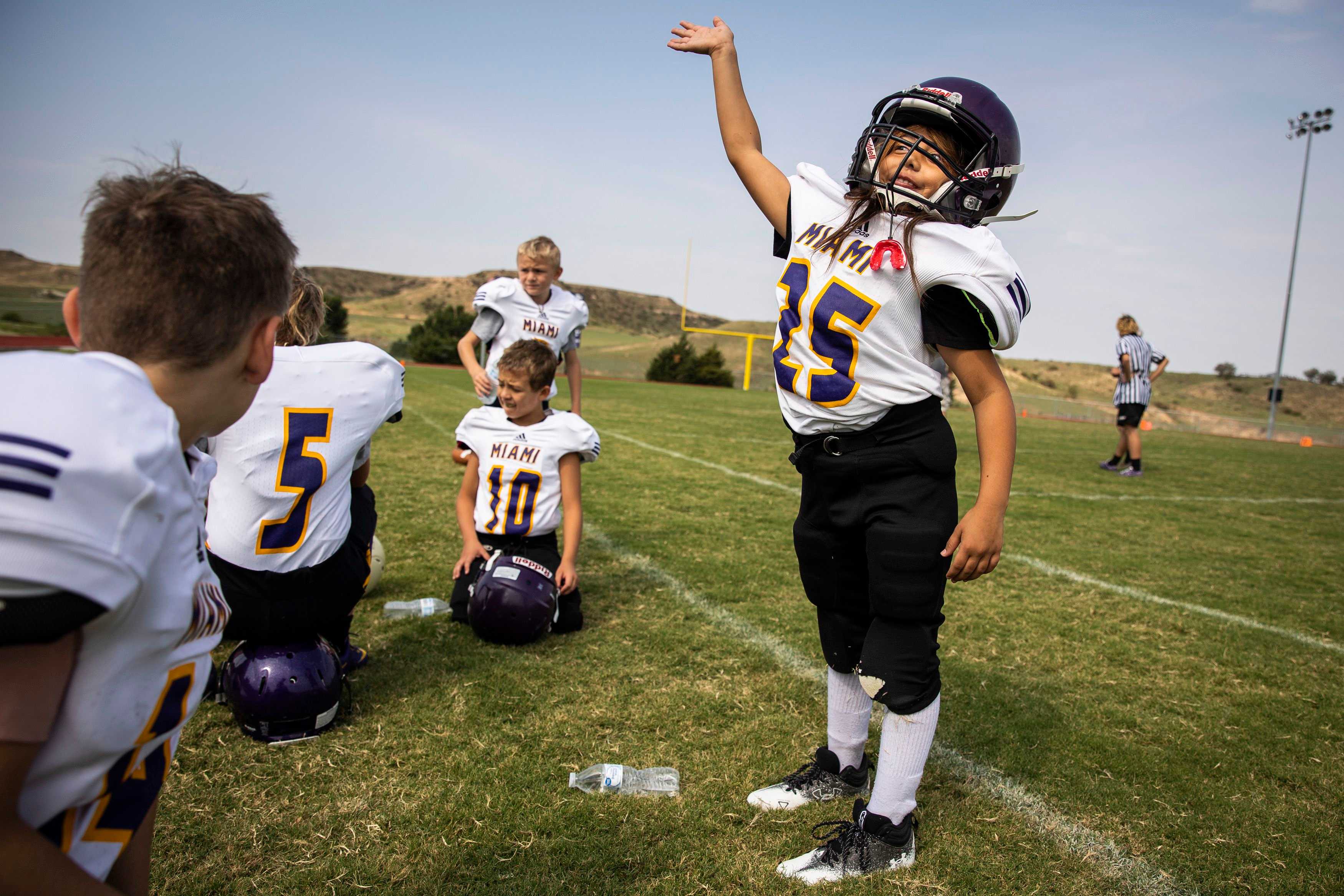 Callie John Calvert waved to her parents in the stands while playing her first football game at Miami ISD in early September.