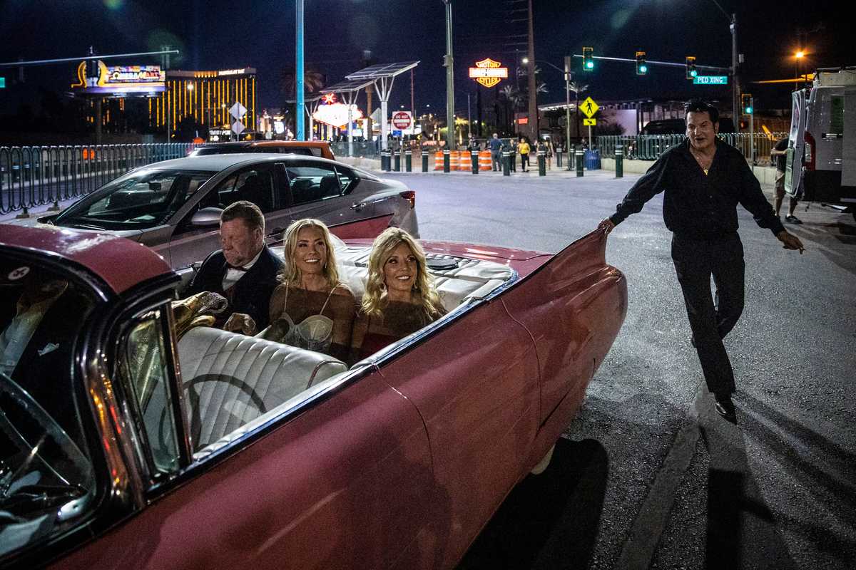 Newlyweds Dean and Susan Norsworthy sat in the back of Elvis’ pink Cadillac with their friend Joy Cross after getting married beneath the famous “Welcome to Las Vegas” sign.