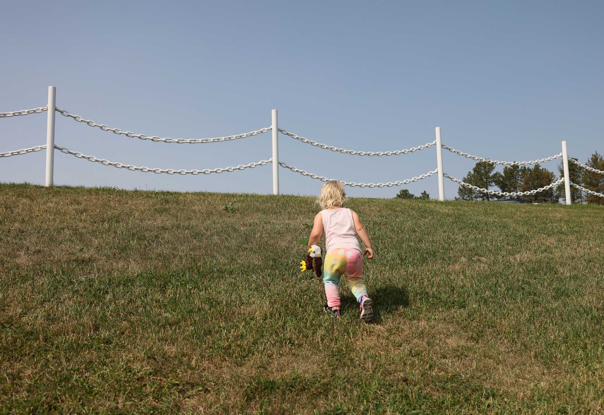 Abigail Pope, 2, made her way up the hill as she and her family arrived at the memorial to the Oglala Lakota warrior, who is famous for his role in the defeat of Custer at the Battle of the Little Bighorn.
