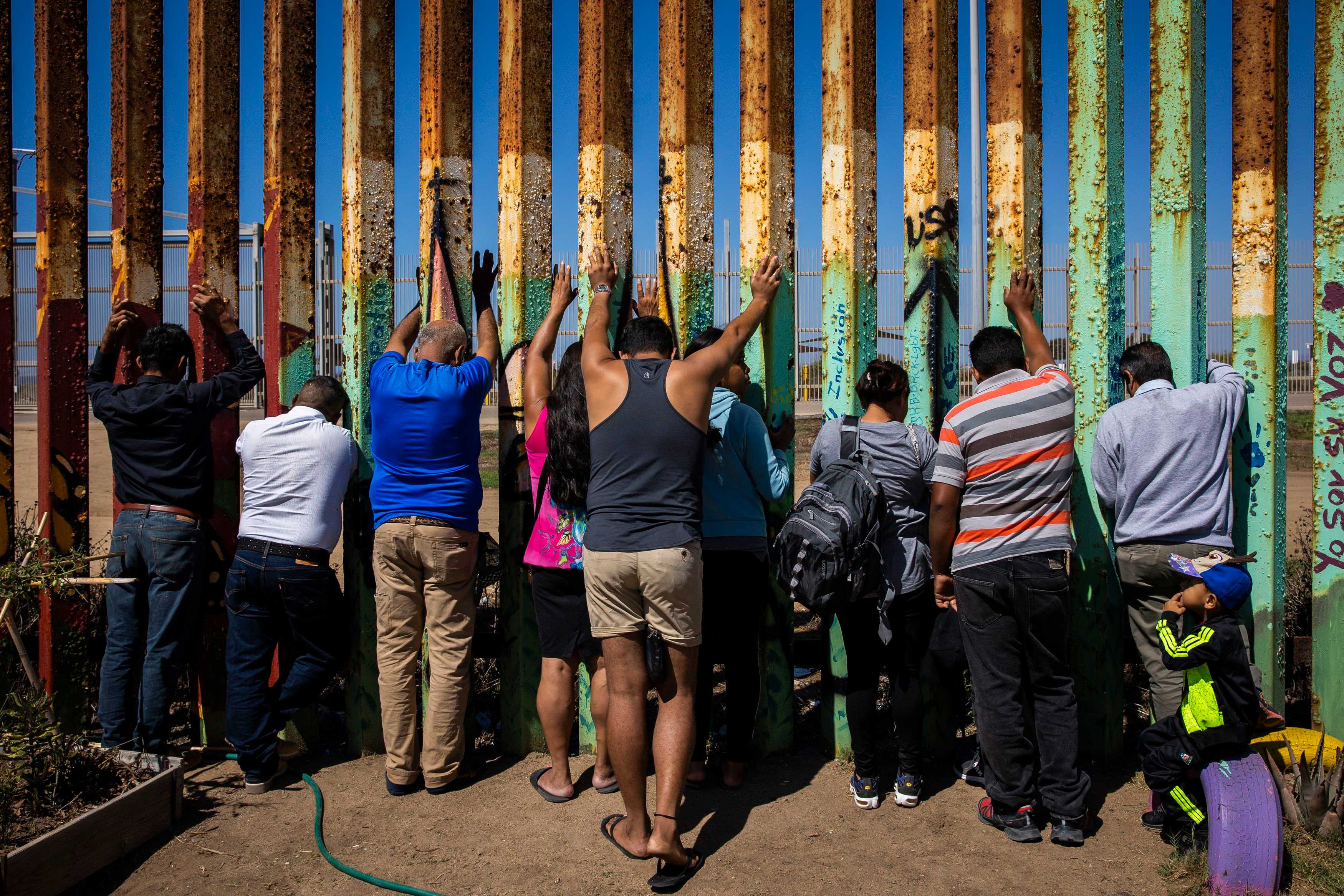 Congregants prayed along the border wall while attending The Border Church, or La Iglesia Fronteriza, on a Sunday in September in Tijuana, Mexico.