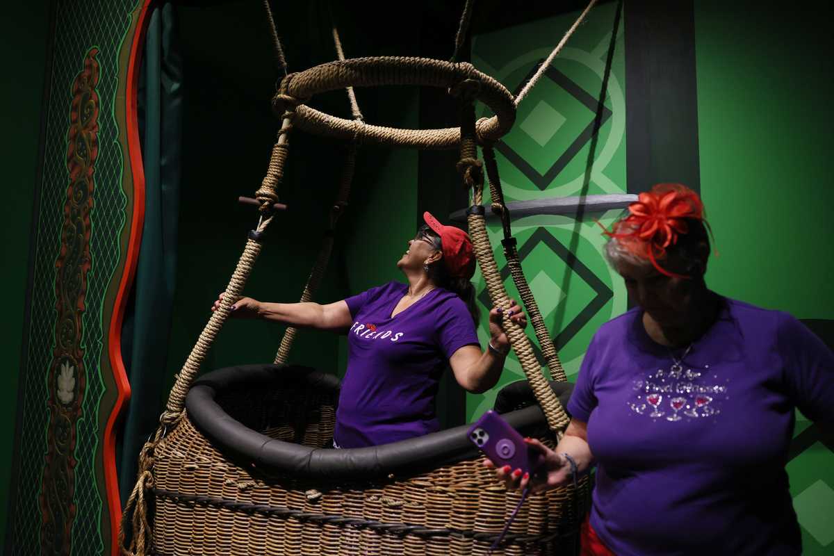  Patricia Cosgrove (left) of California and Mandi Allsobrook of Texas checked out a hot air balloon inside the OZ Museum. Visitors are encouraged to take selfies inside the basket. The pair had come to Kansas for The Red Hat Society’s Regional Convention, in Wichita, and made a two hour and 20 minute journey to the museum.  
