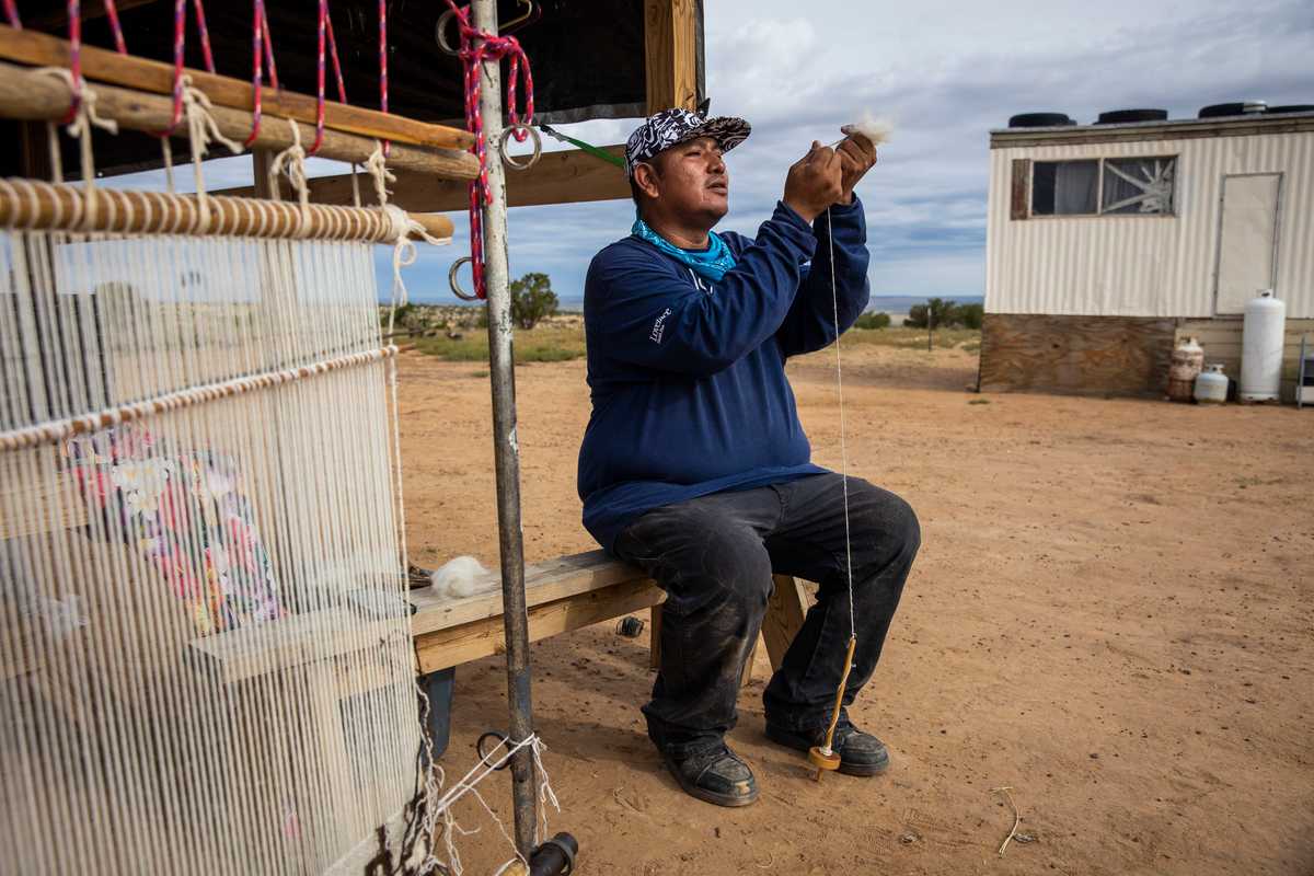 Mace spun wool with a drop spinner. He learned how to weave and care for his sheep from his grandmother.