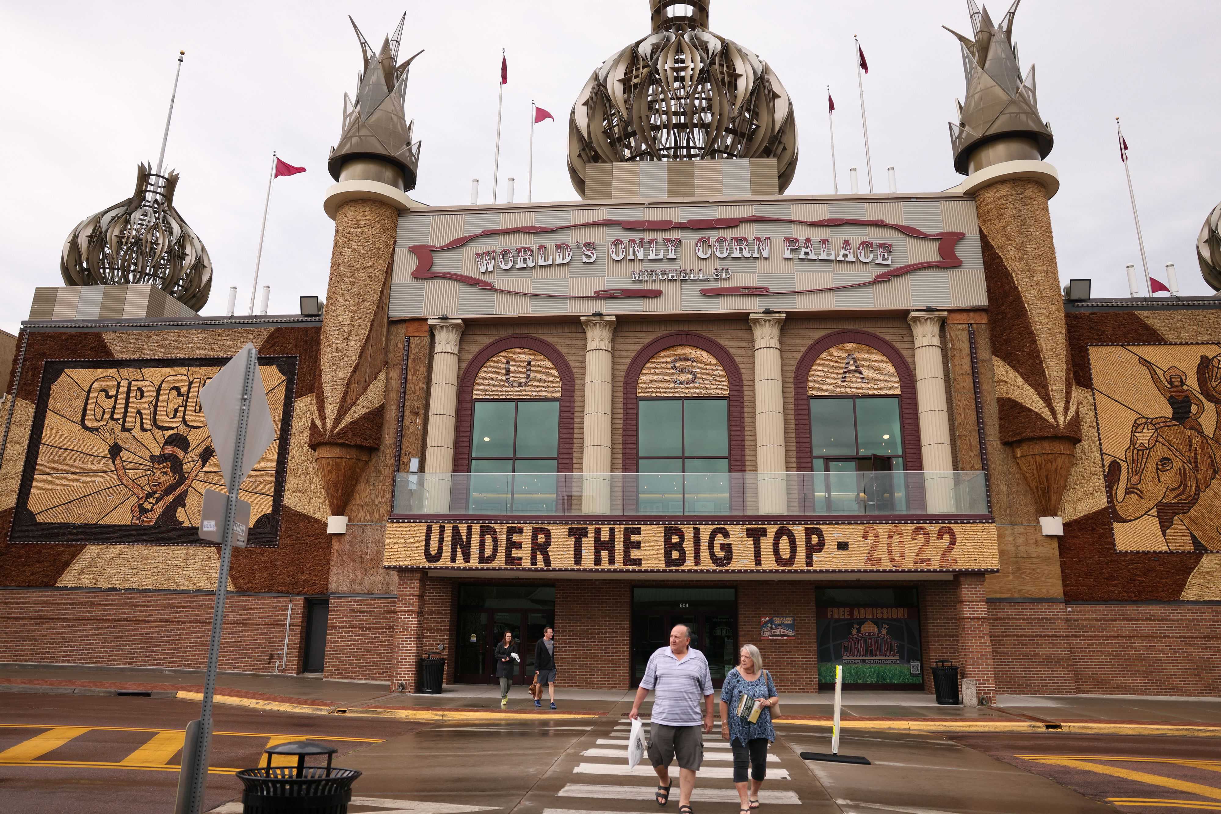 Visitors crossed the street after stopping to check out the World’s Only Corn Palace. The murals on the exterior are made of corn, grains, and grasses. Drought conditions left the organizers short on materials to build this year's murals.