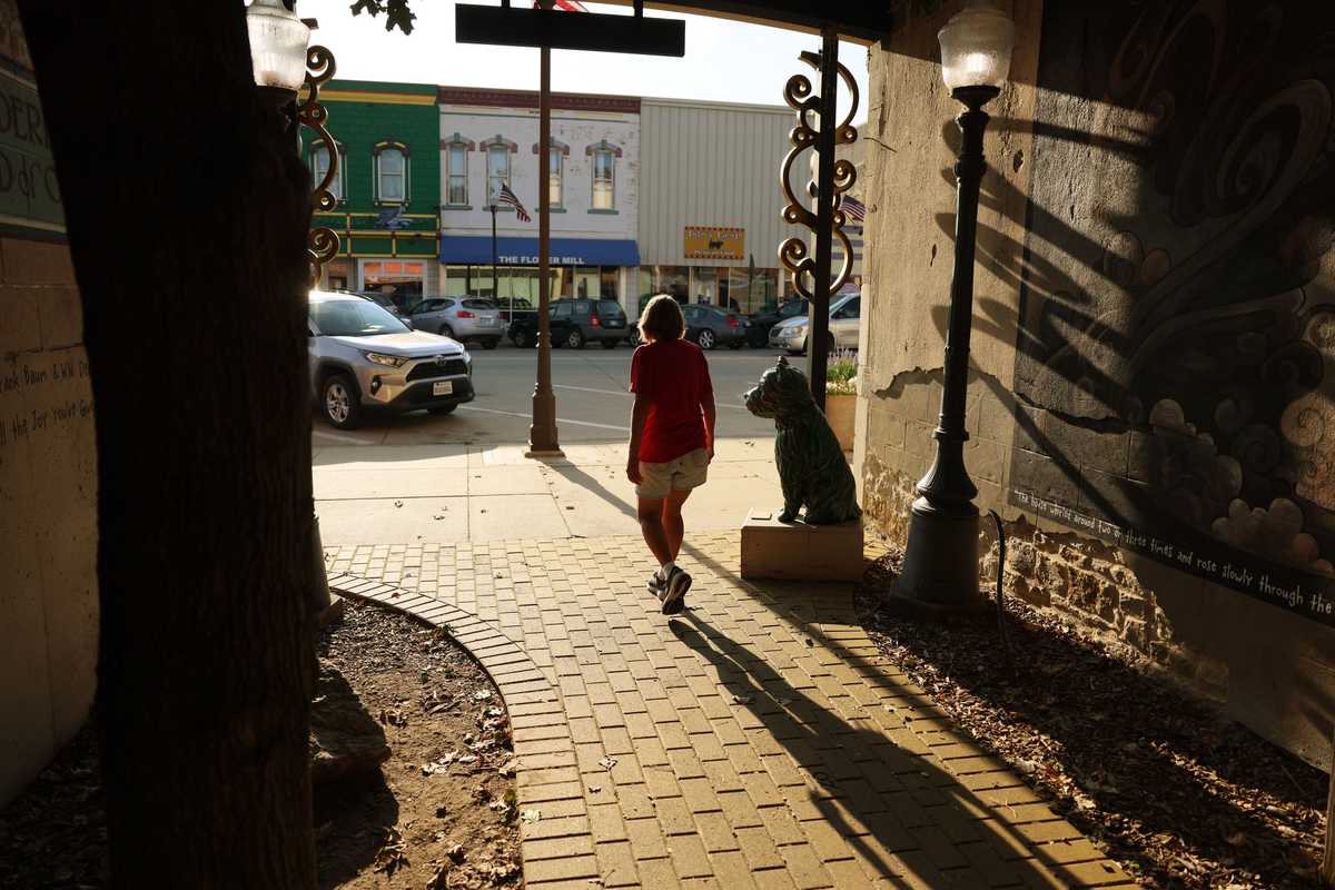 Sally Sharp, who who works for the Friendship House bakery, cast a shadow as she walked down the Yellow Brick Road across from the OZ Museum.  