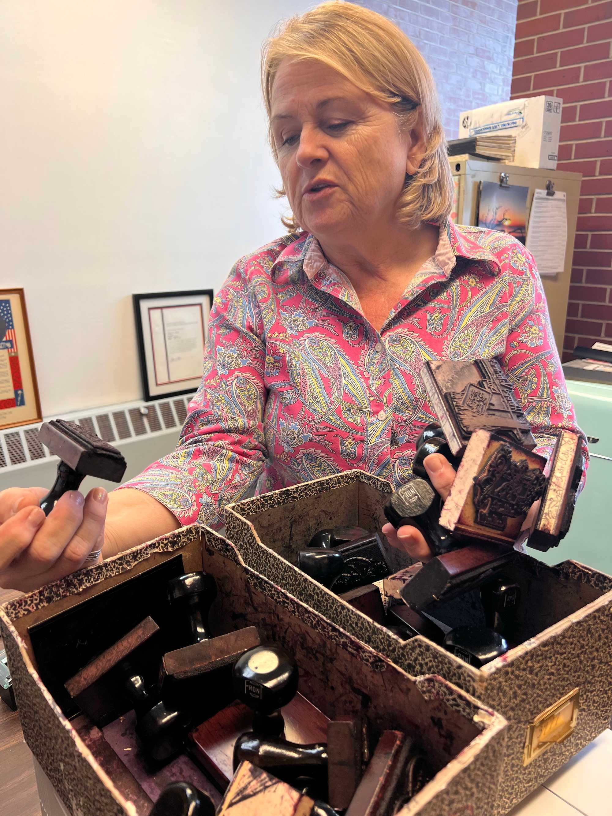 Arlene Paulson, the postmaster of Valentine, has a collection of specialty stamps for postmarking valentines.