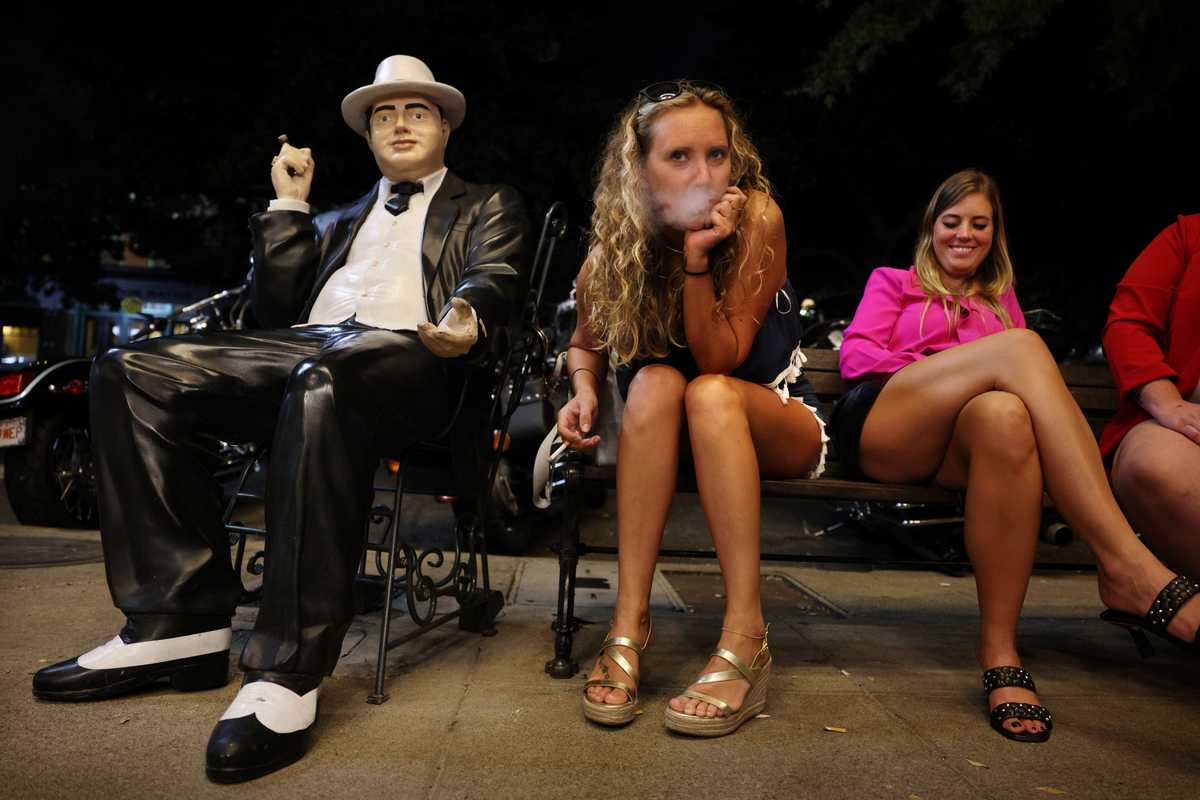 A young woman celebrating her birthday enjoyed time with her friends and a likeness of Al Capone outside The Ohio Club.