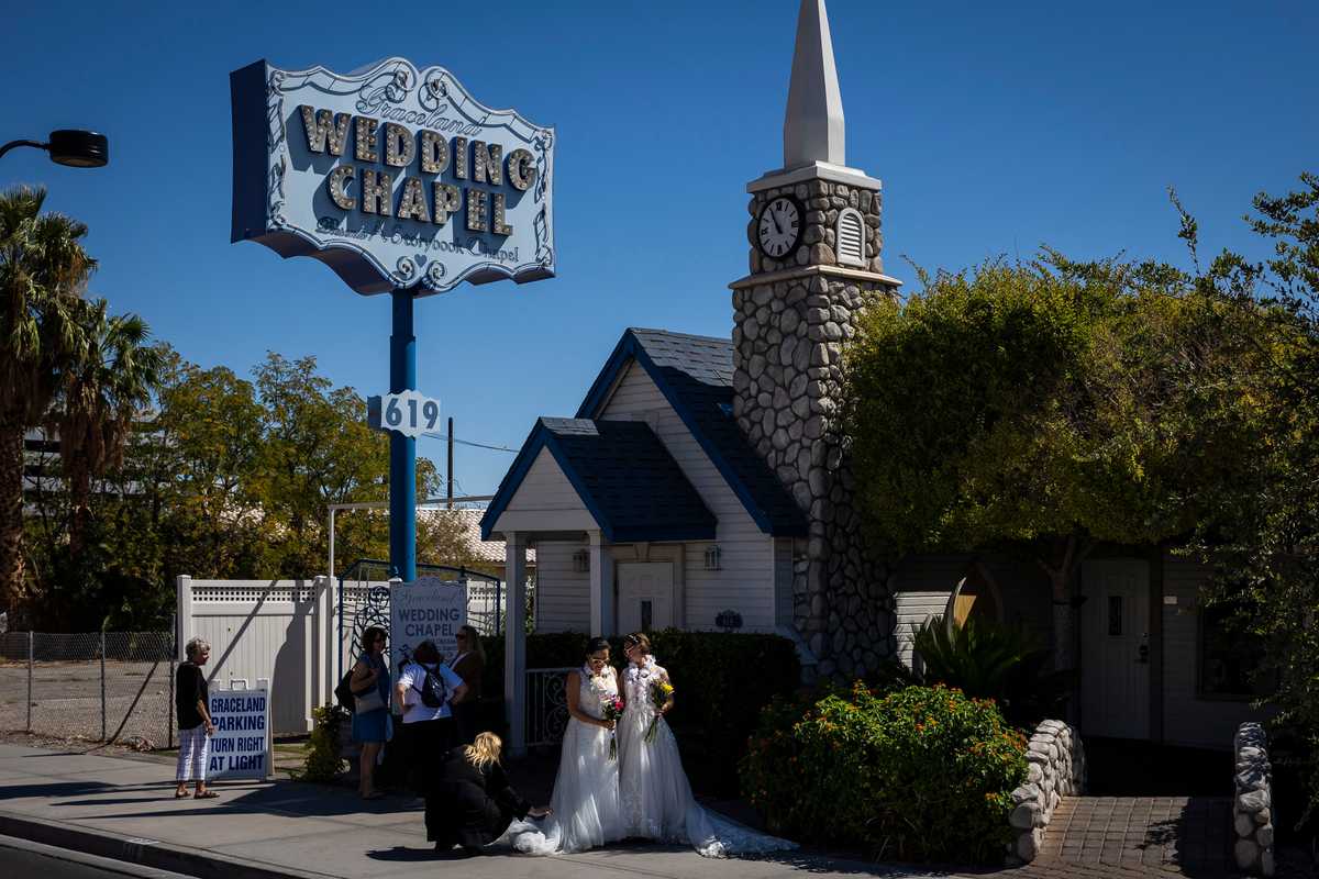 Newly married couple Sarah and Stephanie Logia had their photos taken outside of the Graceland Wedding Chapel in Las Vegas.