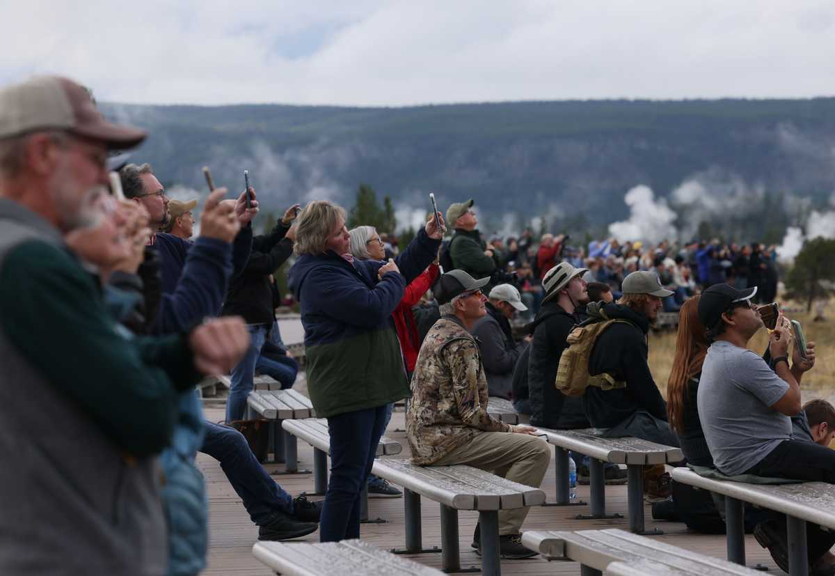 Visitors recorded an Old Faithful eruption on their cellphones.