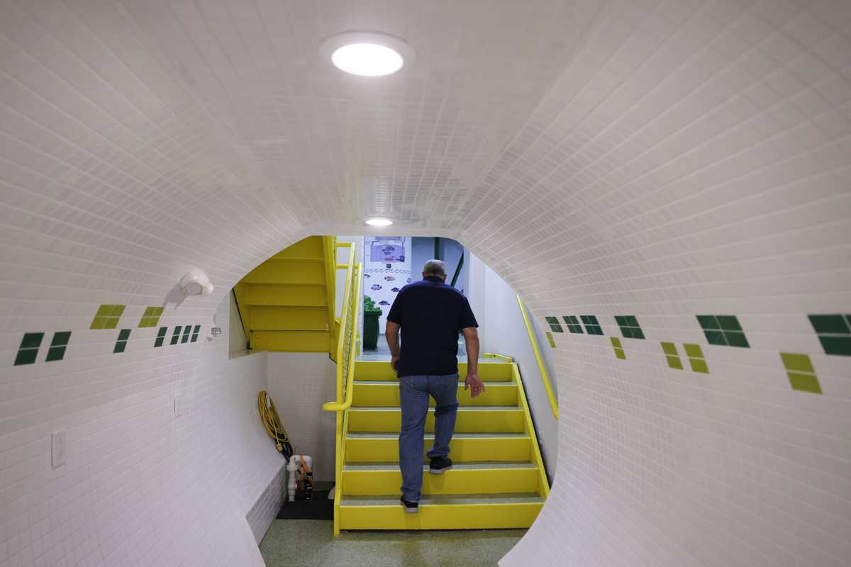  Larry Hall, the developer behind the Survival Condo, lead the way from the market to the hydroponic farm where fresh vegetables are grown deep underground. 