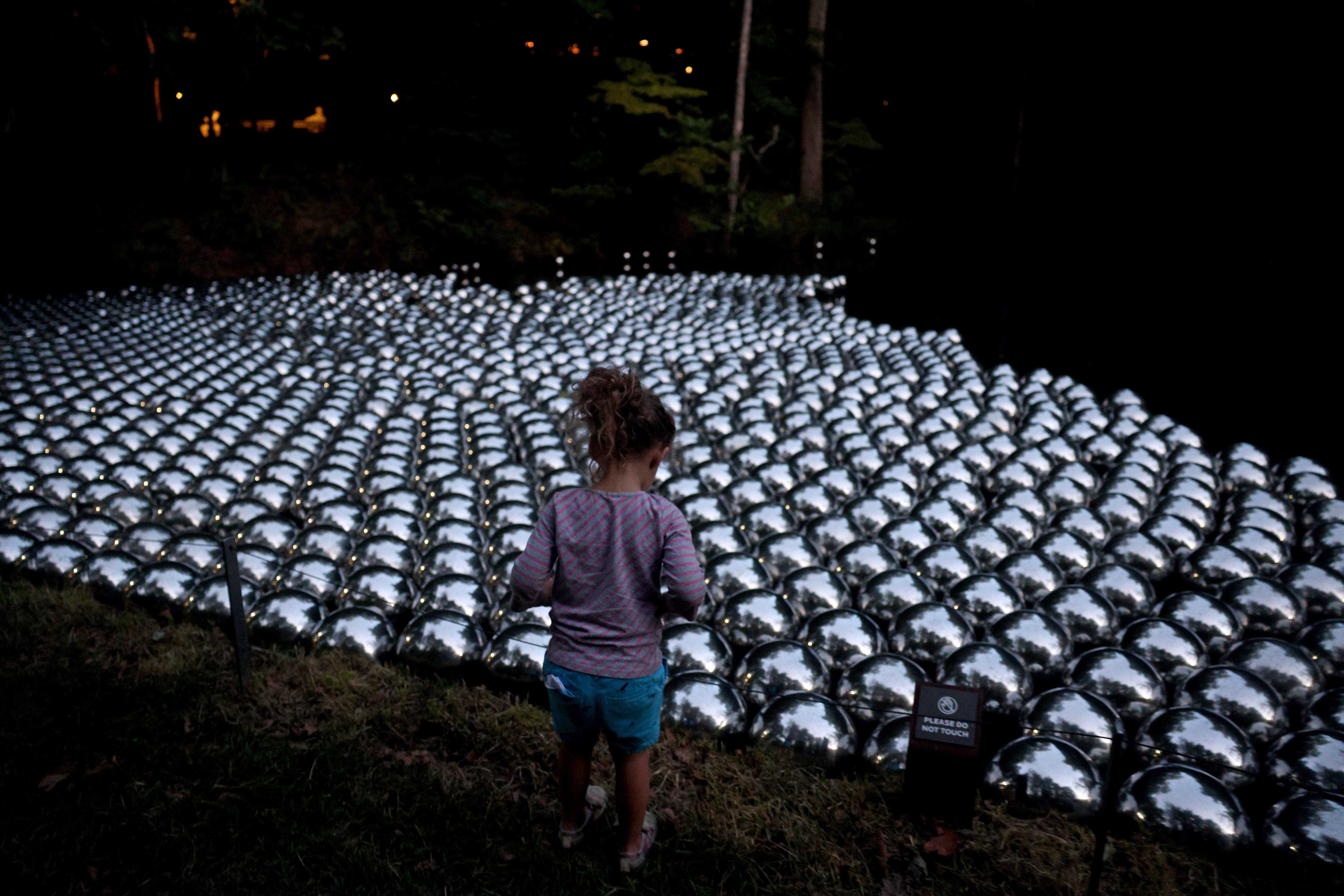 Annora Rose Showers, 3, admired Yayoi Kusama’s Narcissus Garden at Crystal Bridges Museum of American Art in Bentonville, Ark.