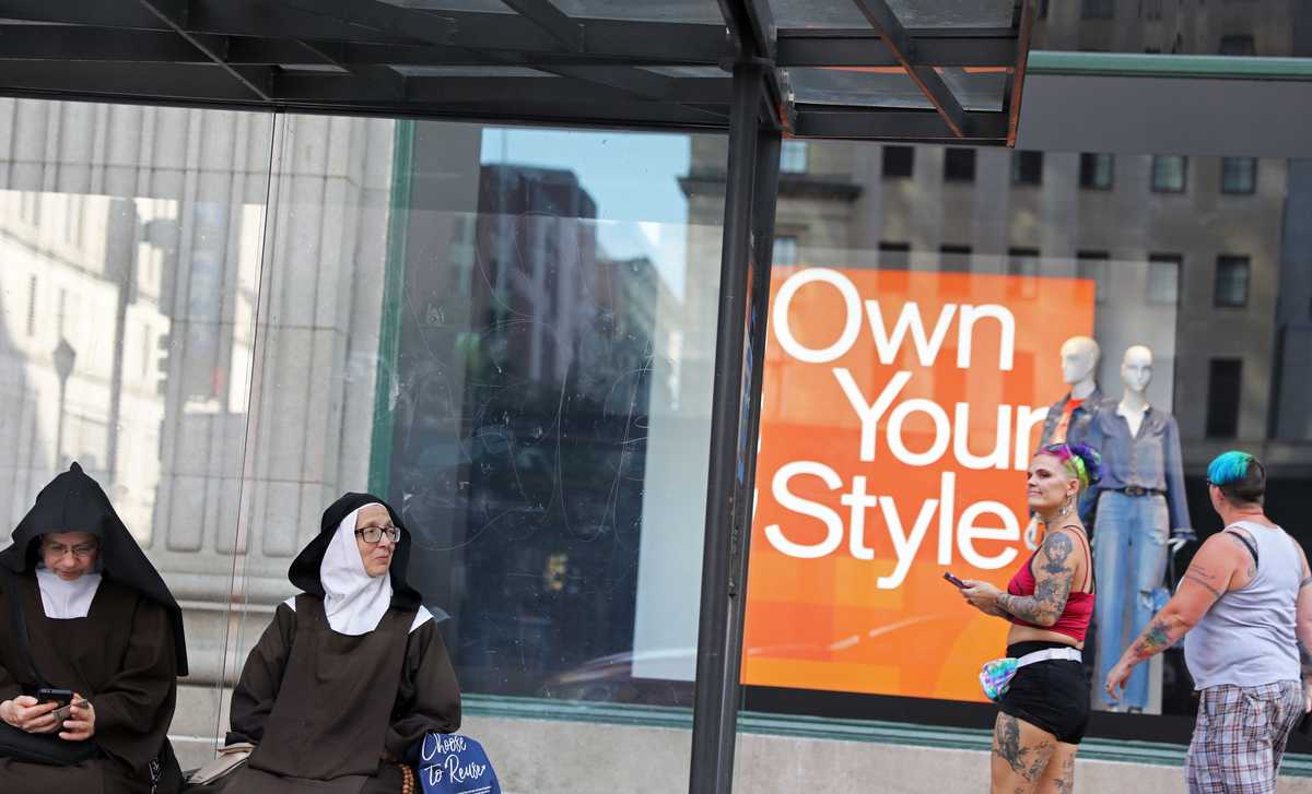 Contrasting fashion styles were seen at a bus stop on Market Street in Philadelphia on Sept. 18.