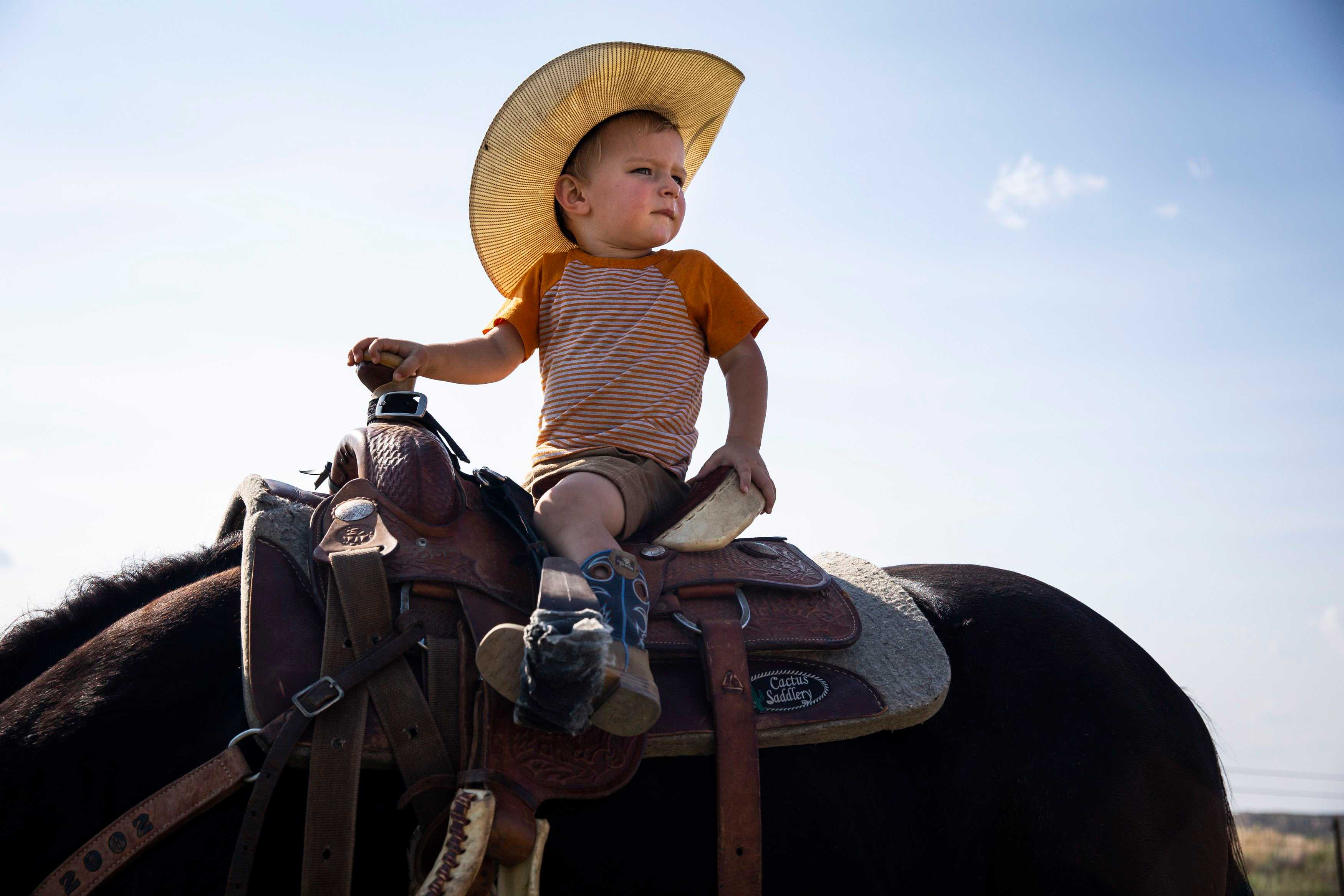 Beck Booze, 2, looked out across his grandparents' ranch while riding a horse in Miami, Texas.