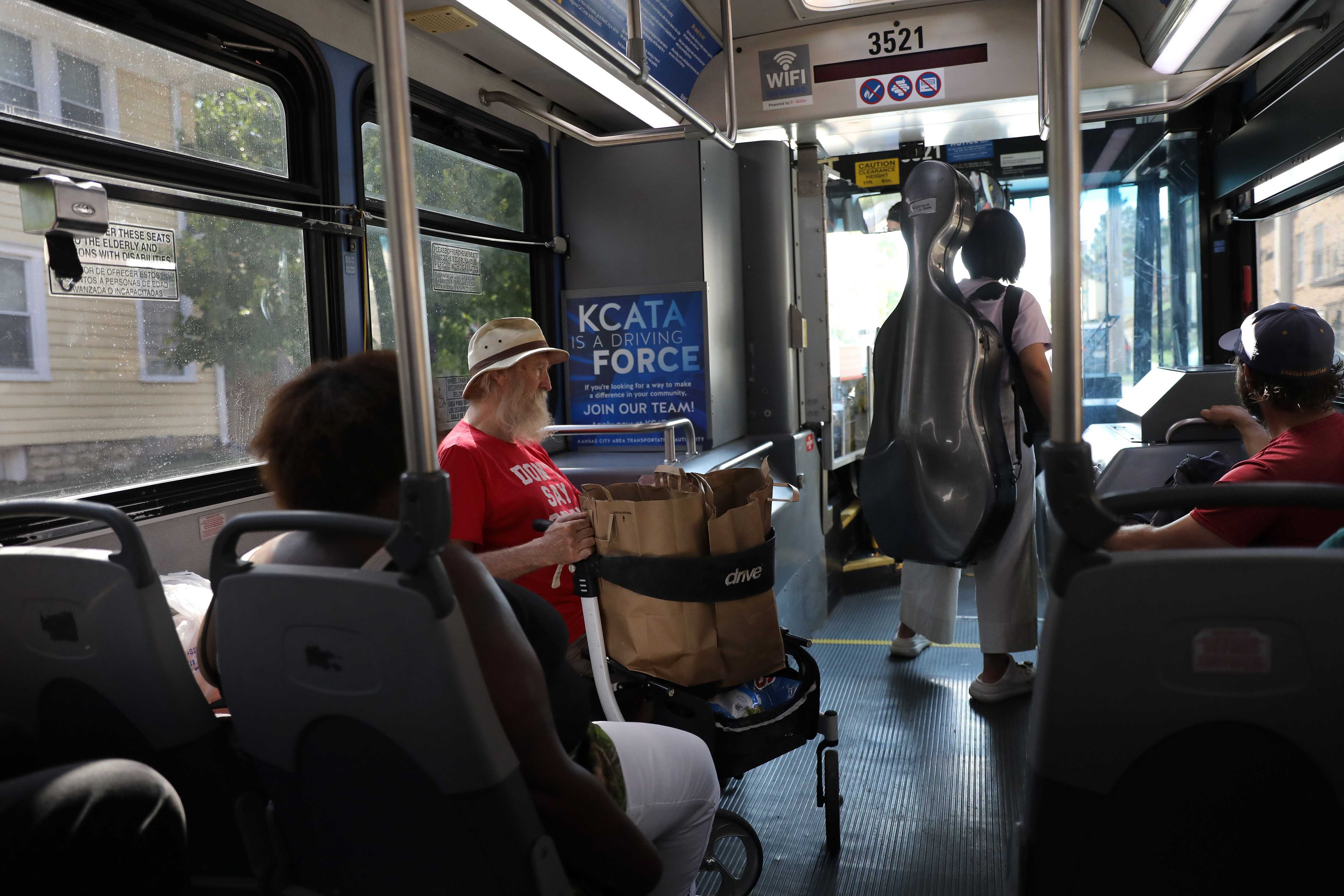Michael Brennan (left), 74, headed home on the bus after grocery shopping in Kansas City, Mo. Kansas City is the biggest city in the country with free public transportation