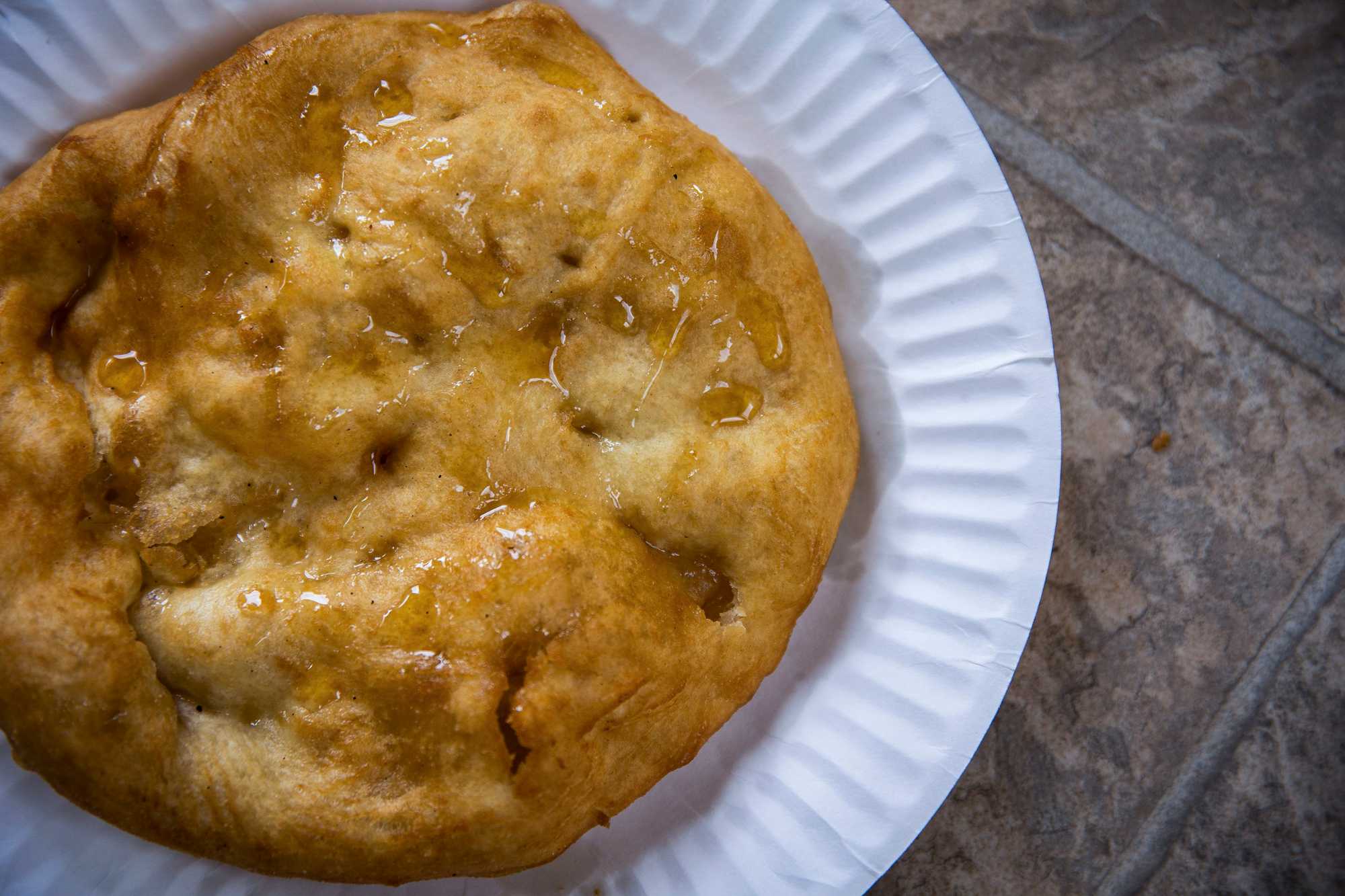 To make fry bread, Kady makes a ball of dough, fries it in hot oil until it puffs up, and then coats it with cinnamon sugar or honey. 