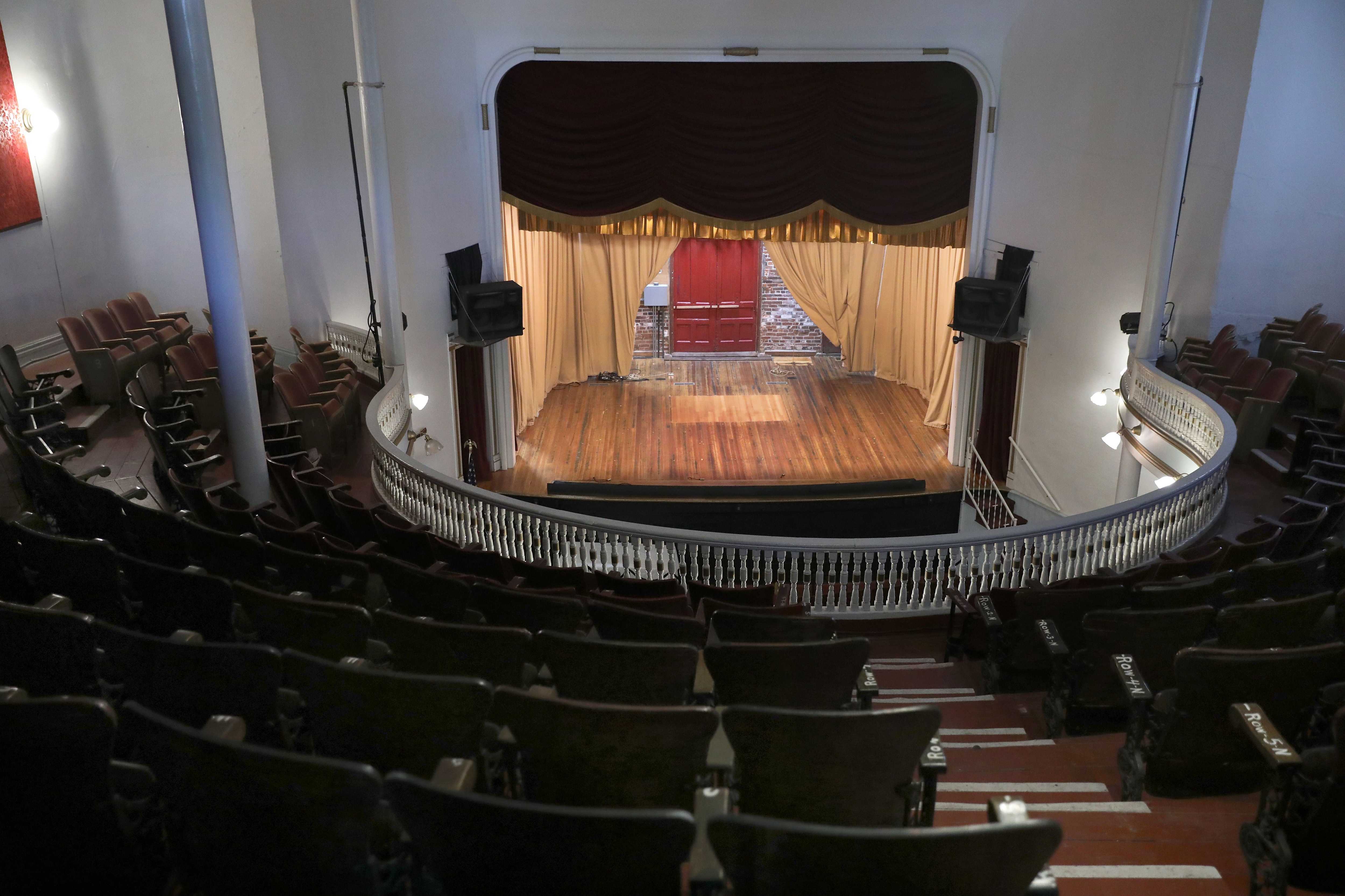 The light patch of wood at the center of the stage in What Cheer's old opera house has been repaired. A section had been cut out to accommodate a magician’s act.