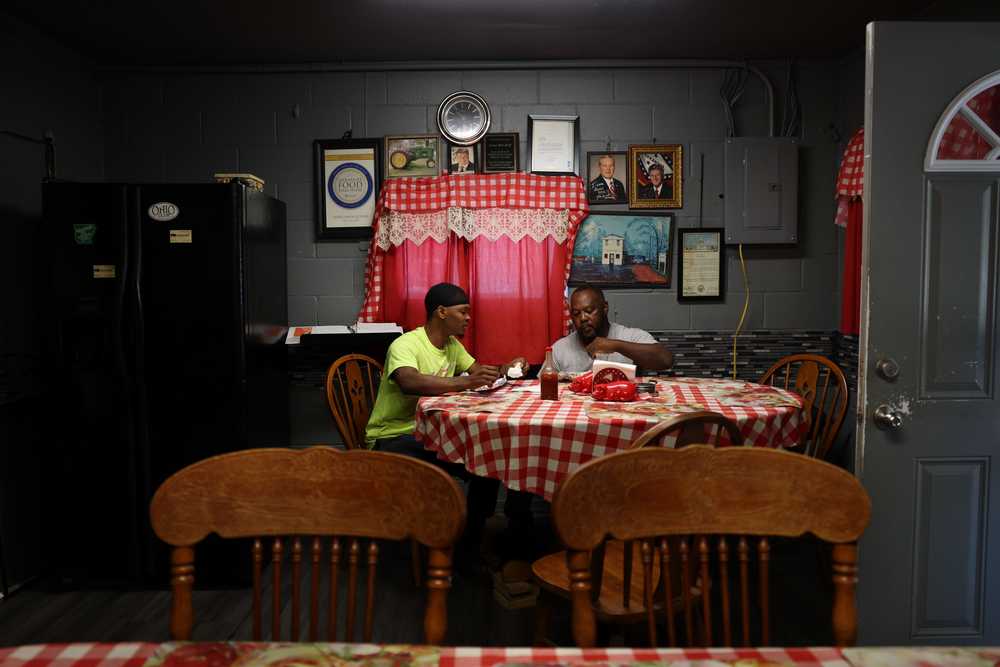 Marcus Isom (left) and his father, Melvin, enjoyed lunch at Jones Bar-B-Q Diner in Marianna, Ark., on a September afternoon.