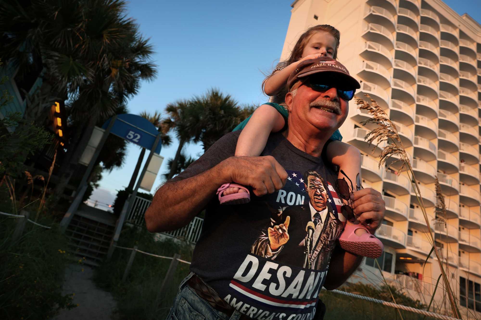 Bob Kufer carried his granddaughter, Shera, from the beach in Panama City Beach.
