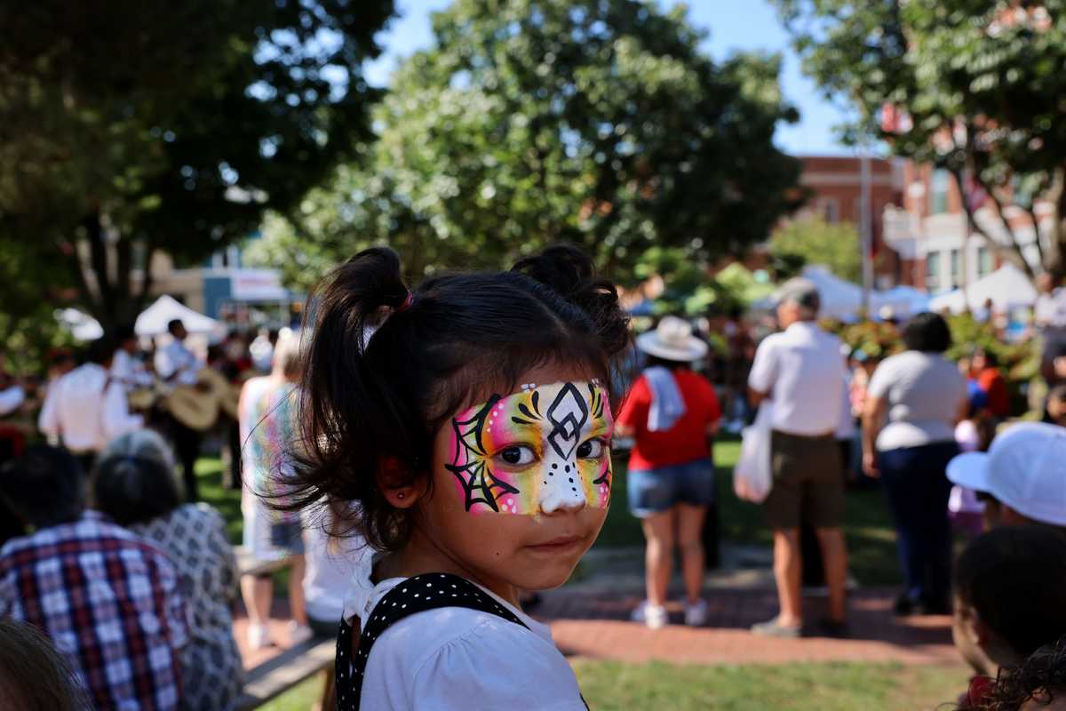 Isabella Estrada, 5, displayed her freshly painted face during the Bentonville Farmers Market On the Square.