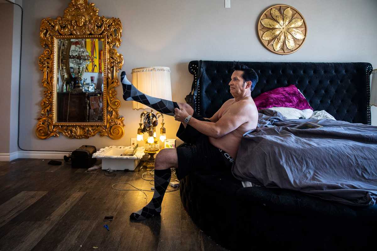 Jesse Grice, an Elvis impersonator for more than 30 years, put on his socks in his Las Vegas home.