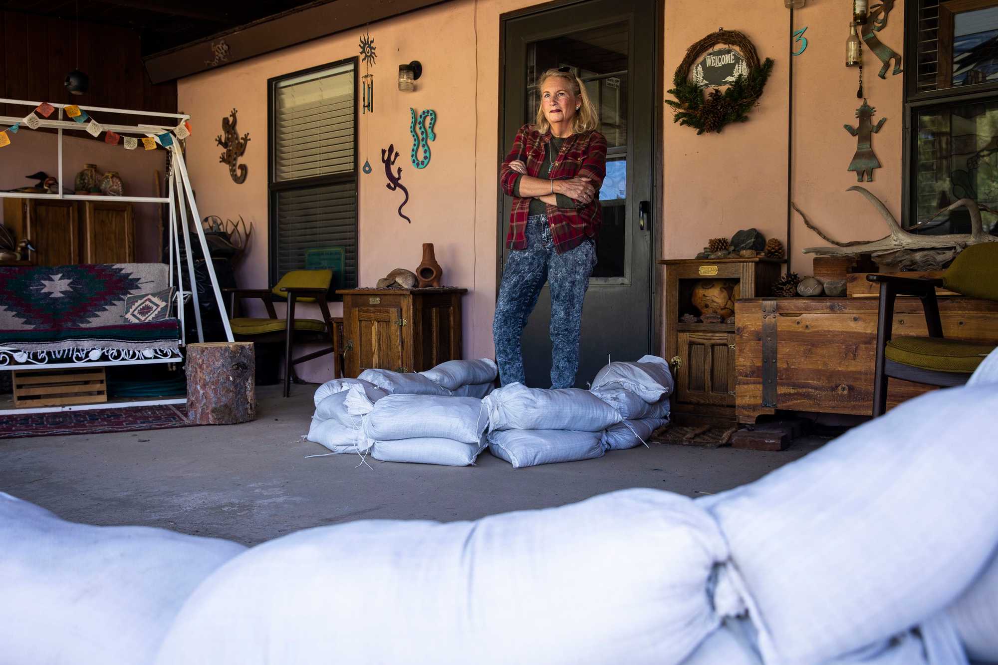 Cyn Palmer has placed sand bags around her fire damaged house, to try to prevent further damage from flooding. 