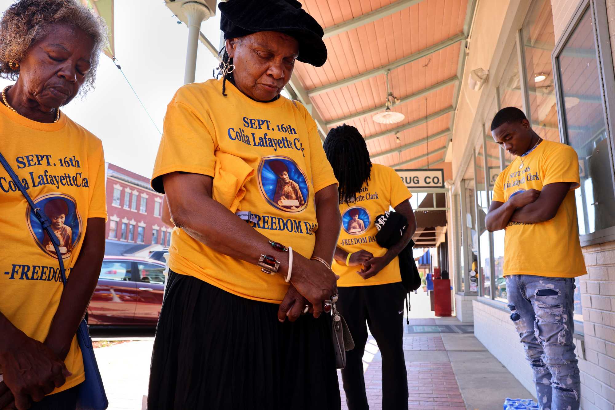 Viola Johnson Douglas (left) and Faya Touré shared in a moment of silence outside Carter Drug Co. 