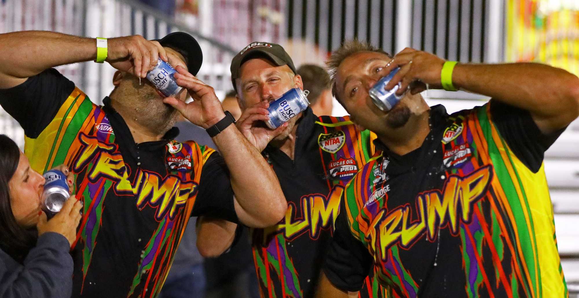 Shane Kellogg (right) of Forest, Ohio, and his team shotgunned beer after his win at The Sandwich Fair in Illinois. 
