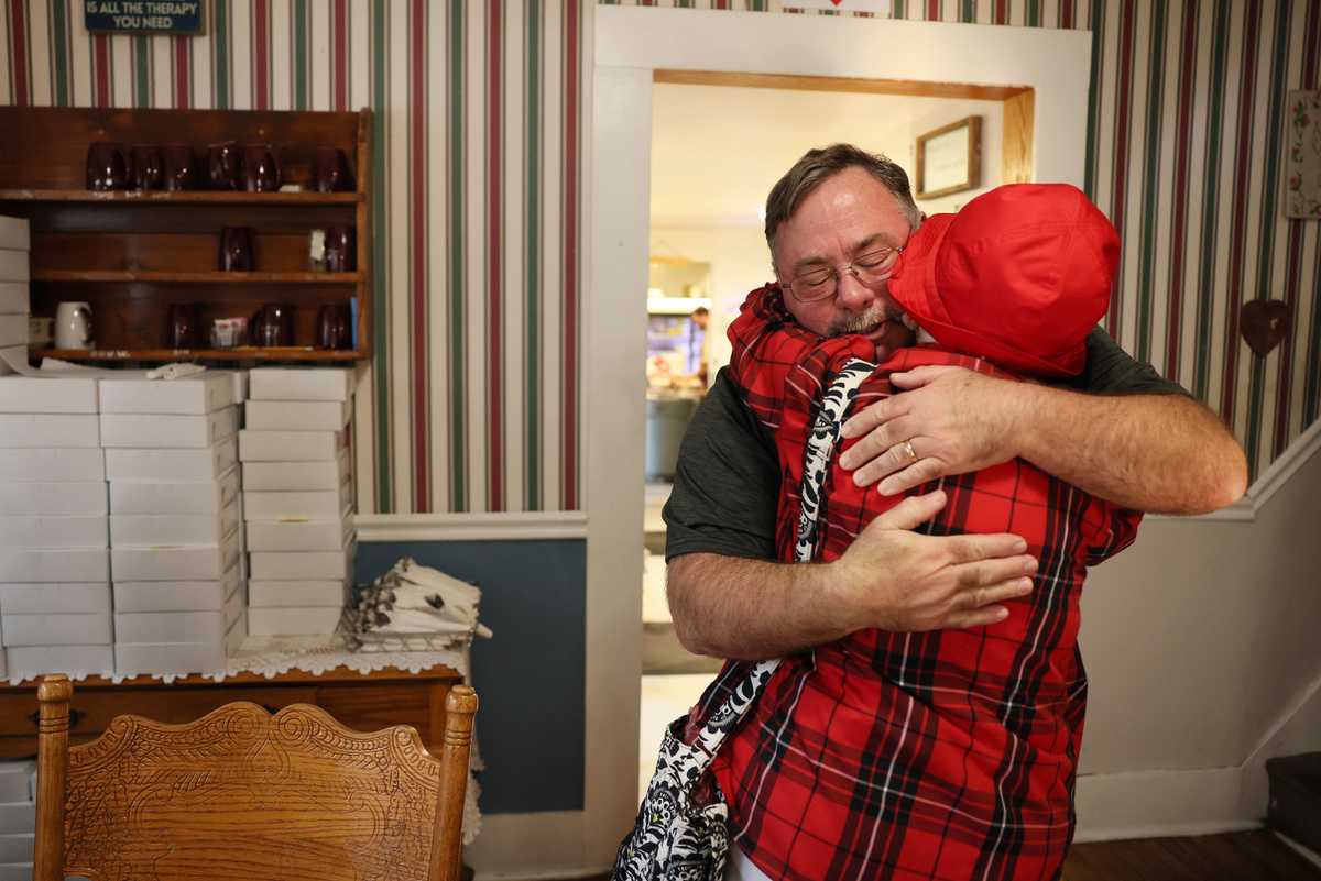 Mike Pray, owner of the Friendship House bakery, embraced Bobbie Peters, 90, one of a group of people who come to his restaurant every morning at 8 a.m. to have breakfast together. Every Sunday members of the core group bring people from their church, which Pray said had been a tremendous help to the business during slow times. 