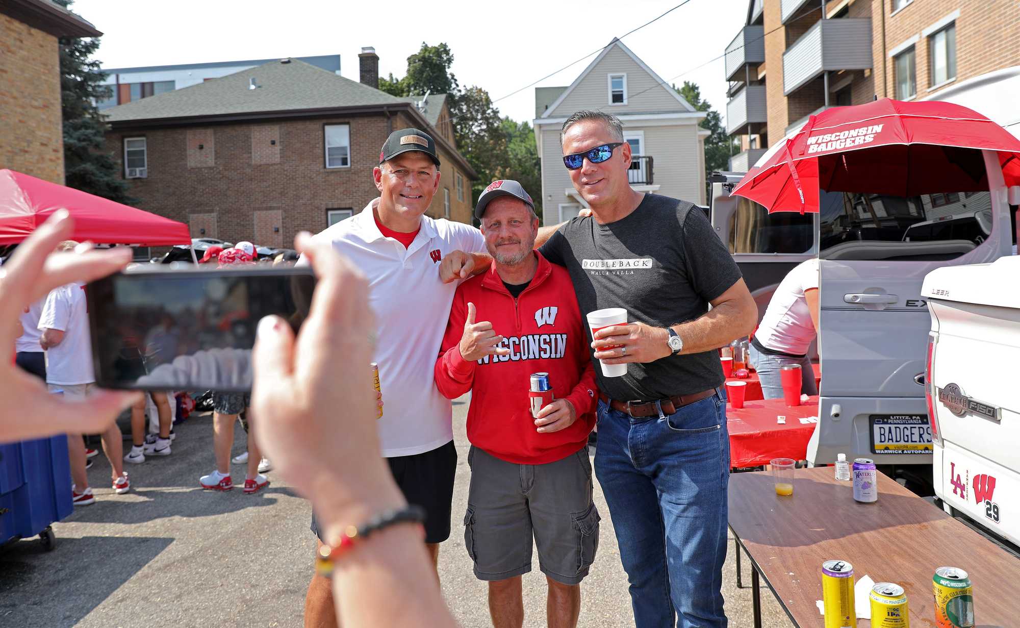 Former New England Patriots teammates Todd Rucci (left) and Drew Bledsoe (right) tailgated with Bruce Herbig of Kauai, Hawaii. Herbig's son, Nick, is an outside linebacker for Wisconsin. Bledsoe is a Washington State alum. 
