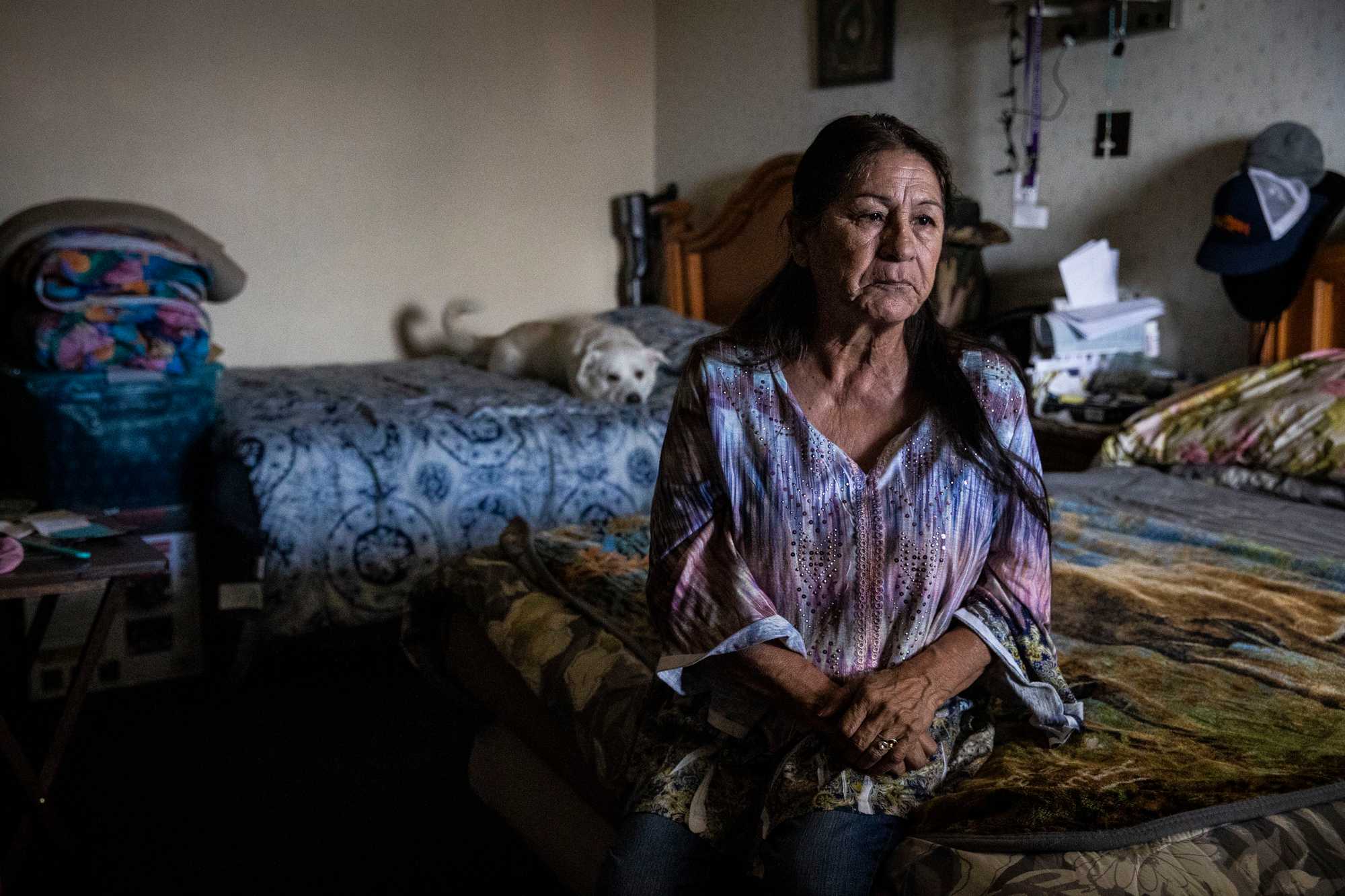 Anita Rivera in the motel room where she and her husband, Andrew Vigil, have been living with their dog, Polar Bear, since their home was destroyed by a wildfire.

