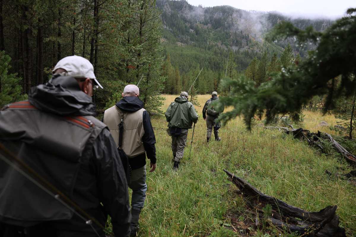 From left: Cliff Myers and his son, Jeff, both of California, headed out with Avrum Clapper and his son, Lawrence, both of Portland, Ore., as they headed the Madison River to fly fish. 